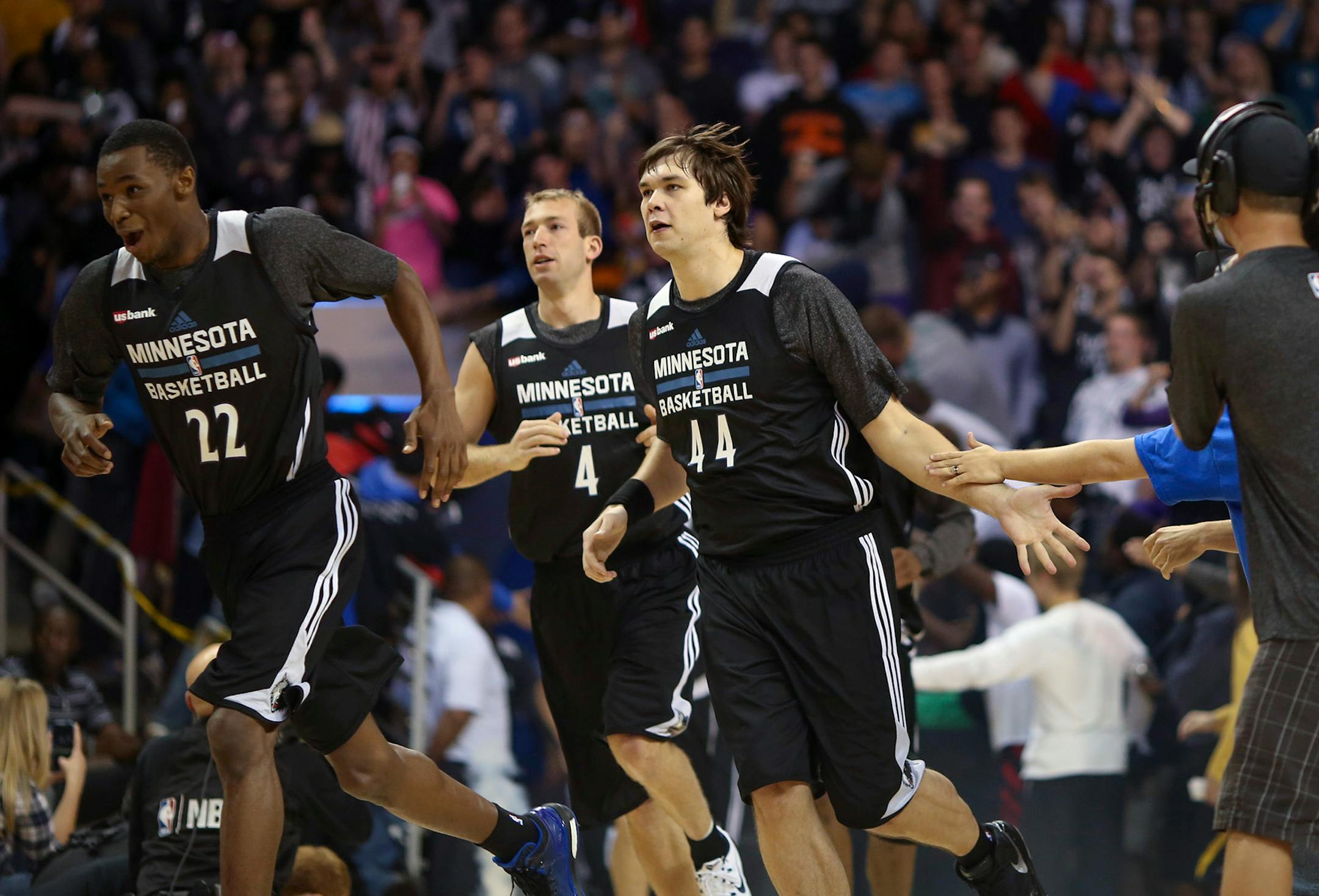 Andrew Wiggins (22), Kyrylo Fesenko (44), and Robbie Hummel (4) ran onto the court for the Dunks After Dark event late Monday night at Bresnan Arena in Taylor Center in Mankato.