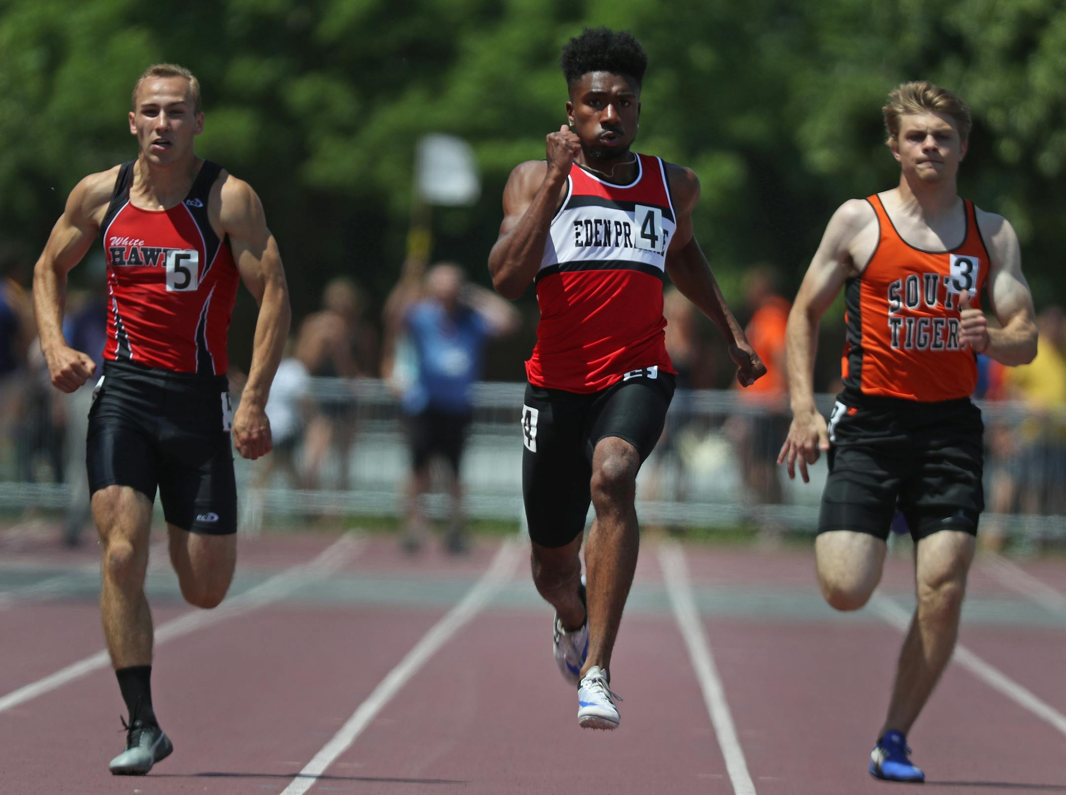 Denzel Brown, center, of Eden Prairie won the 200 for the second year in a row, finishing in 20.97 seconds.
