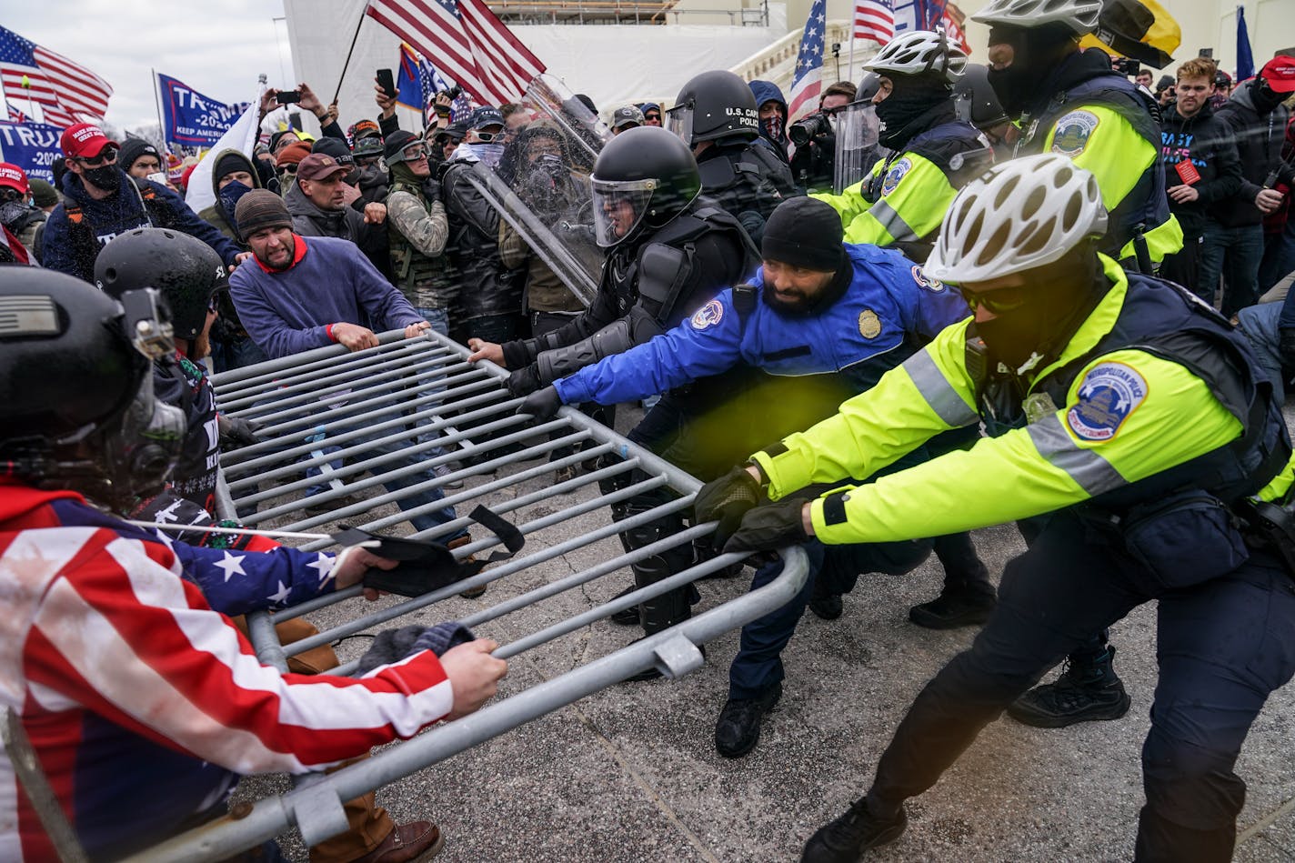 FILE - In this Jan. 6, 2021, file photo, Trump supporters try to break through a police barrier at the Capitol in Washington.