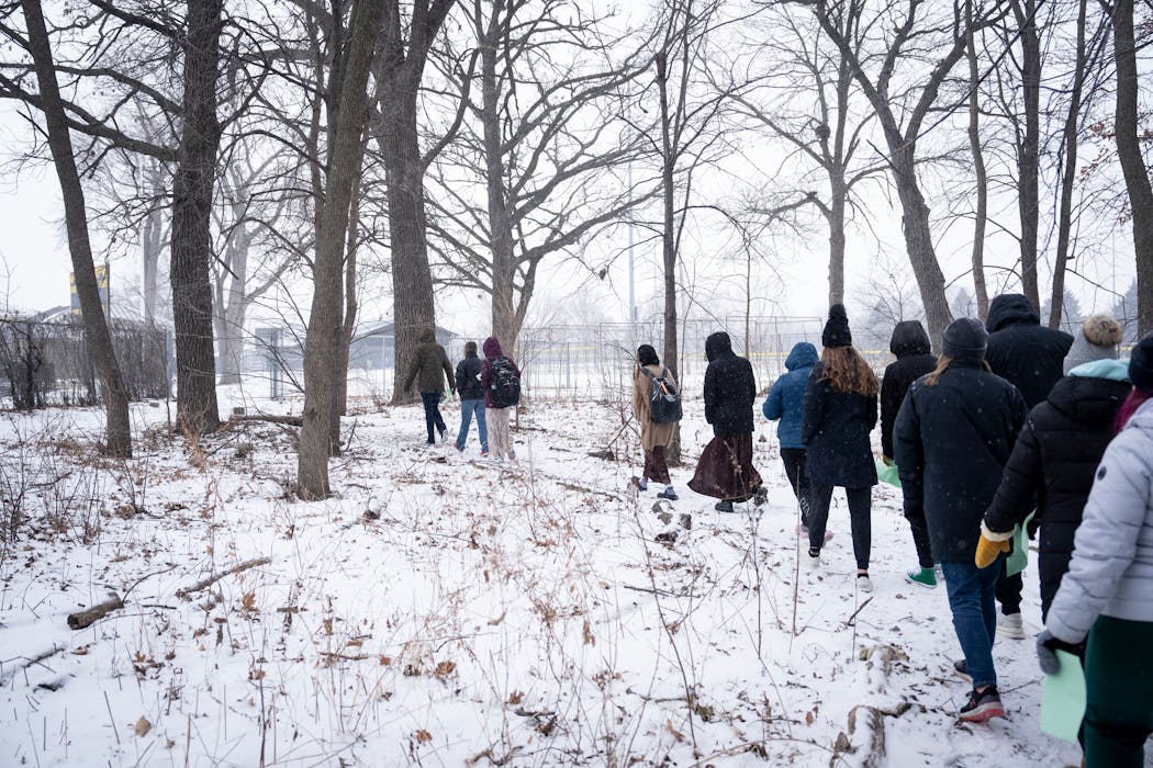 Students in Julia Battern’s Ecology class walk through the woods back to class at Mankato East High School on Thursday, Jan. 18.