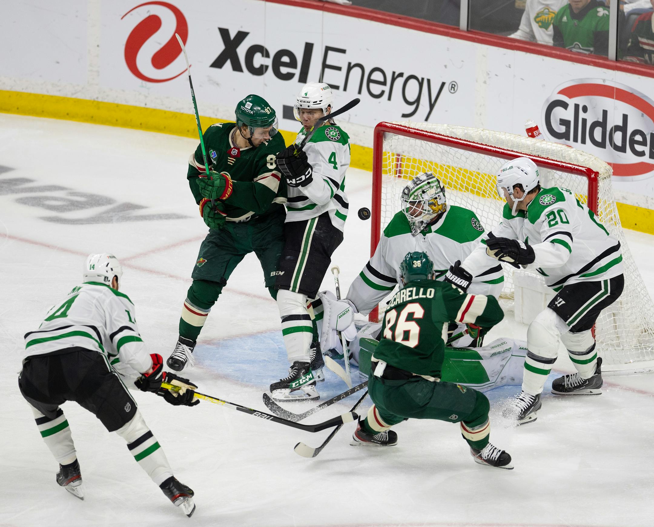 The puck sailed through a crowded crease in front of Dallas Stars goaltender Jake Oettinger (29) in the third period.