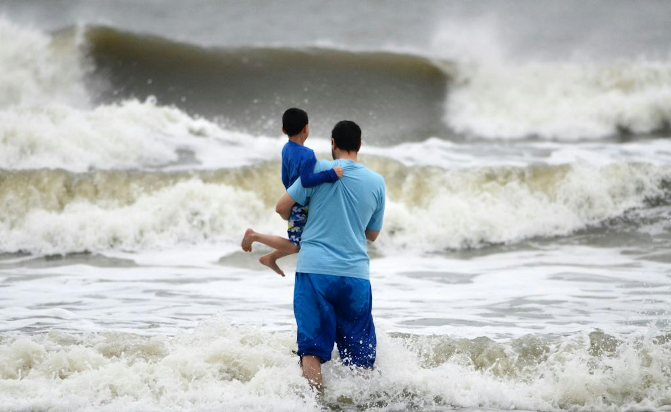 Beach goers watch waves generated by Hurricane Sandy along a breezy Coligny Beach Park on Hilton Head Island, S.C., Saturday morning, Oct. 27, 2012. Hurricane Sandy _ upgraded again Saturday just hours after forecasters said it had weakened to a tropical storm _ was barreling north from the Caribbean and was expected to make landfall early Tuesday near the Delaware coast, then hit two winter weather systems as it moves inland, creating a hybrid monster storm.