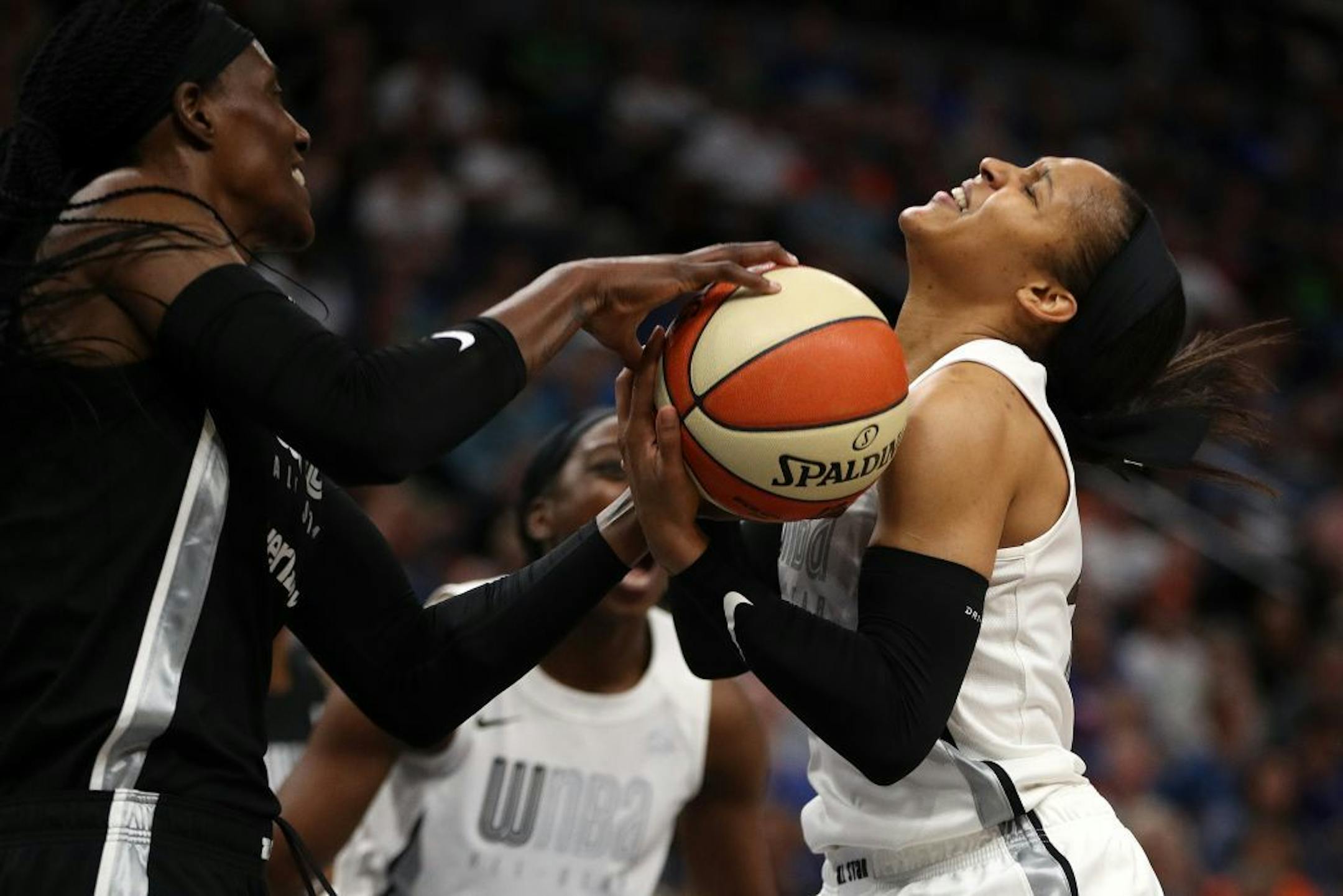 Lynx teammates Maya Moore (right) and Sylvia Fowles (left), on different sides in the WNBA All-Star Game, battled for a loose ball. Moore was named the game's MVP for the third straight year.