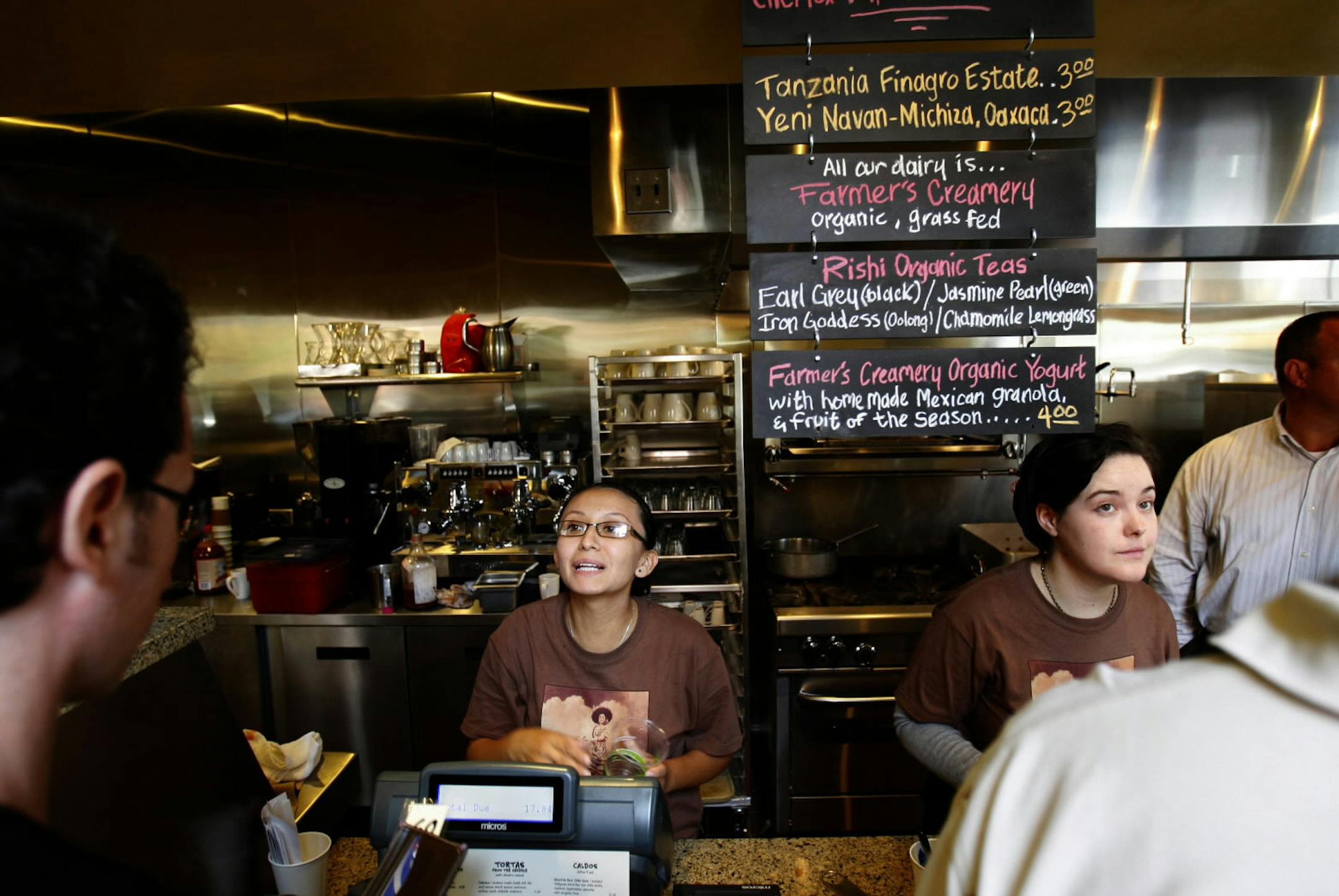 Cashiers try to keep up with the crush of customers at the opening of Xoco, Rick Bayless' new restaurant of Mexican street food, Tuesday, September 8 2009 . (Alex Garcia/Chicago Tribune) ..OUTSIDE TRIBUNE CO.- NO MAGS, NO SALES, NO INTERNET, NO TV, CHICAGO OUT.. 00310797A xoco ORG XMIT: CHI0909081650170284