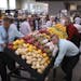 A crew rolled a display of fresh produce to the front of the store Monday afternoon.