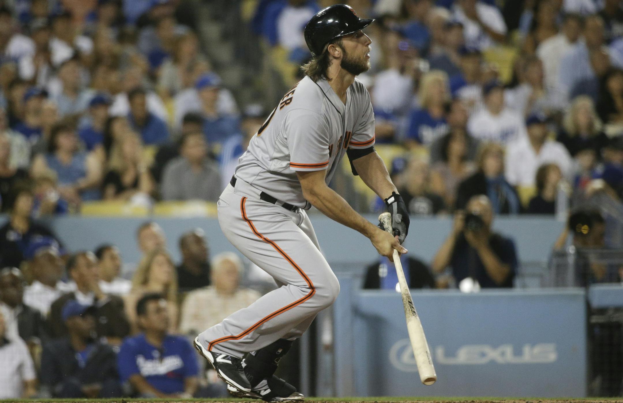 San Francisco Giants starting pitcher Madison Bumgarner watches after hitting a two-run home run during the third inning of a baseball game against the Los Angeles Dodgers Tuesday, Sept. 23, 2014, in Los Angeles. (AP Photo/Jae C. Hong) ORG XMIT: NYOTK