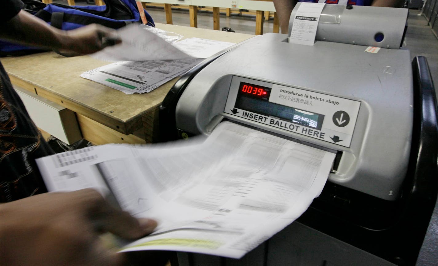 Cook County Board of Elections workers count paper ballots in Chicago.