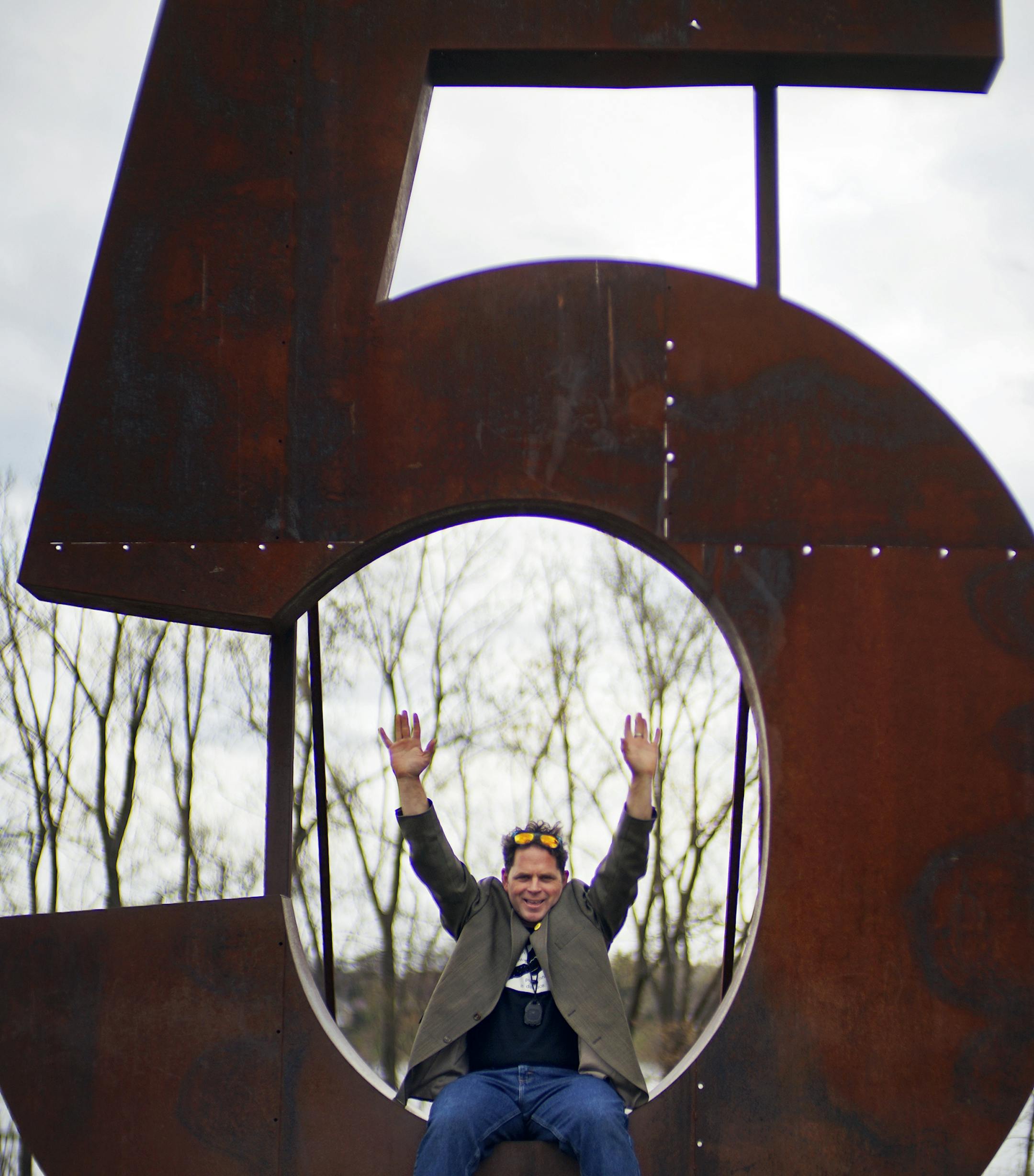 At Silverwood Park in St. Anthony Main on National High Five Day, Andrew MacGuffie sat on his whimsical steel sculpture. He is using the event as a fundraiser for cancer.] Richard Tsong-Taatarii/rtsong-taatarii@startribune.com