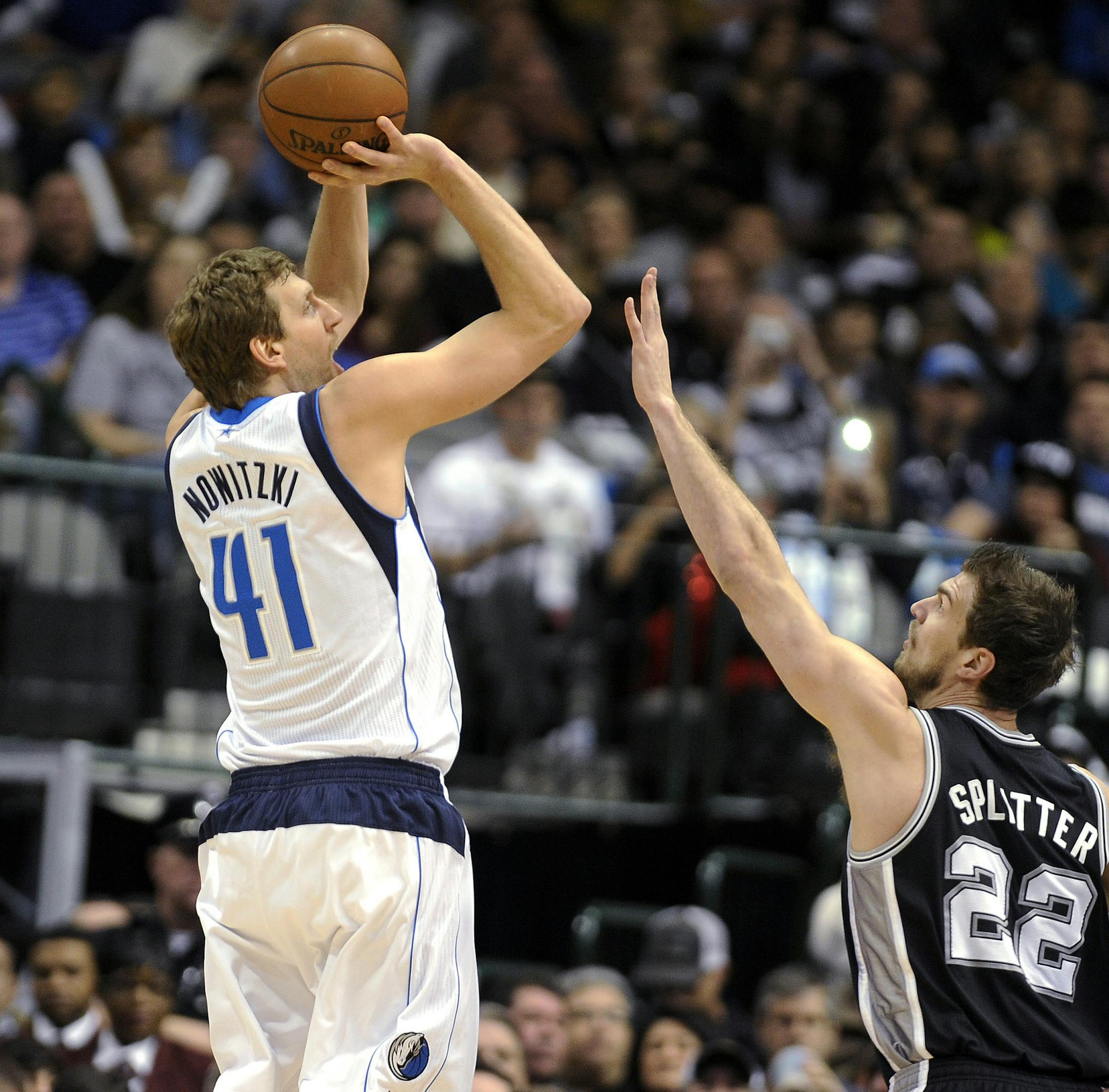 Dallas Mavericks forward Dirk Nowitzki (41) shoots over San Antonio Spurs center Tiago Splitter (22) during the first half of an NBA basketball game, Thursday, Dec. 26, 2013, in Dallas. (AP Photo/Matt Strasen)