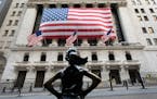 The Fearless Girl statue stands in front of the New York Stock Exchange, Monday, March 16, 2020 in New York.
