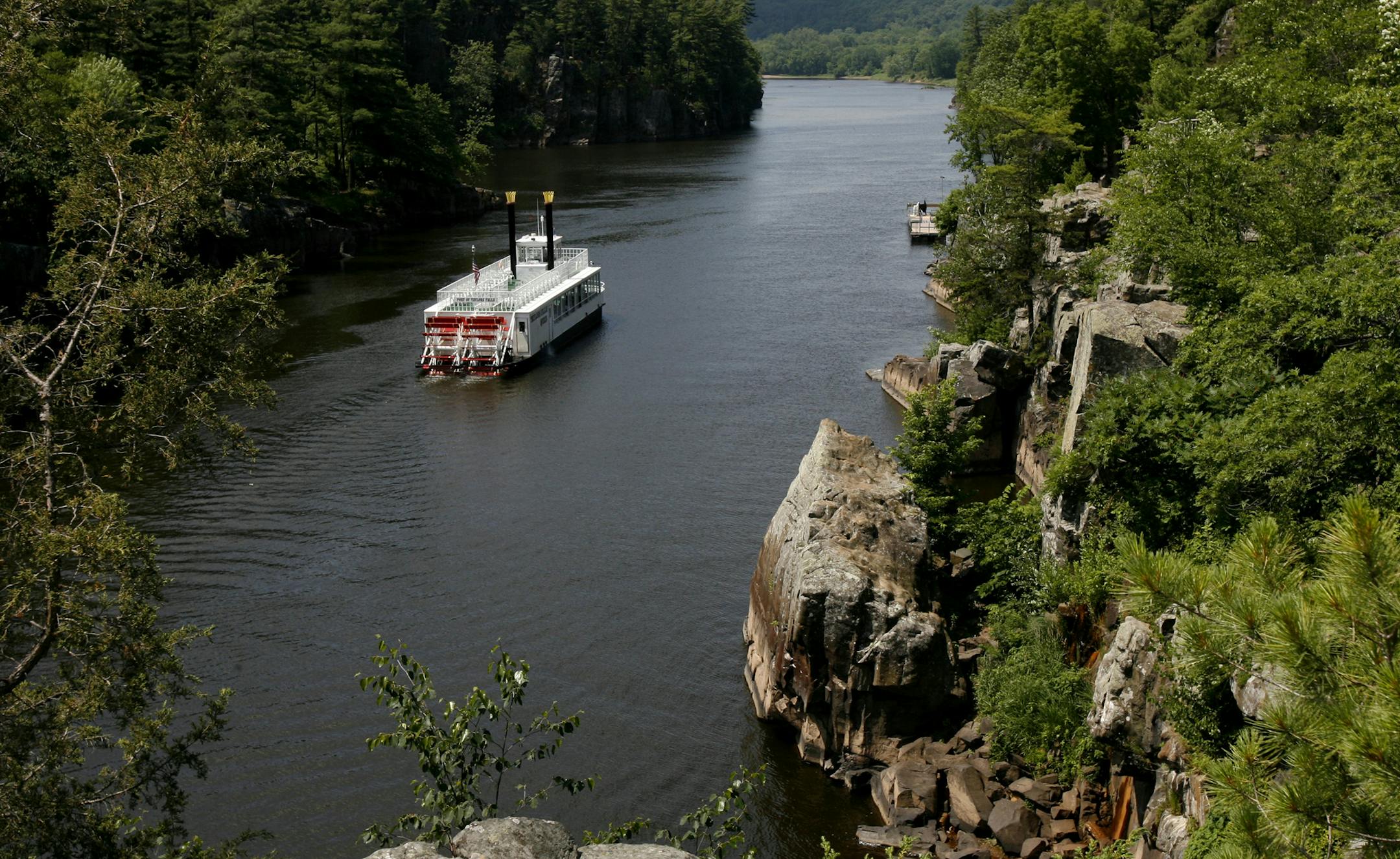 A paddleboat floats down the St. Croix River through Interstate State Park near Taylors Falls, one of the most visited parks in Minnesota.