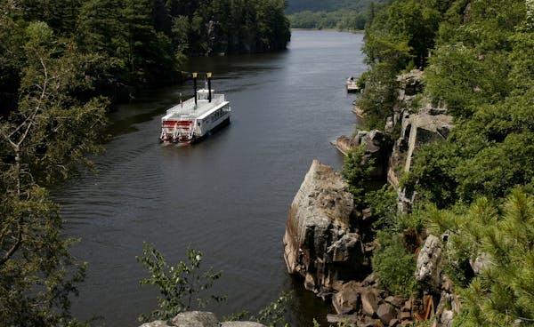 A paddleboat floats down the St. Croix River through Interstate State Park near Taylors Falls, one of the most visited parks in Minnesota.