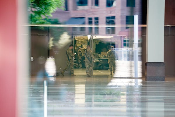 National Guard troops staged at the Minneapolis Convention Center. ] MARK VANCLEAVE ¥ The Minnesota National Guard deployed in the wake of George Flo