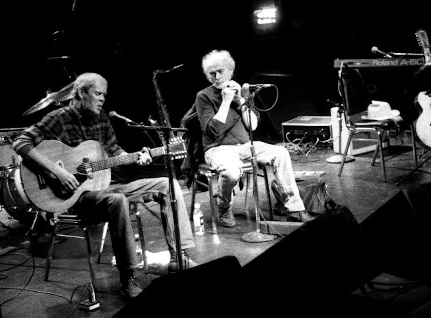 " Spider" John Koerner and Tony Glover appear together in a memorial concert to their former partner " snaker" Dave Ray ( empty chair/hat, right) December 13, 2002 at First Avenue, Minneapolis.