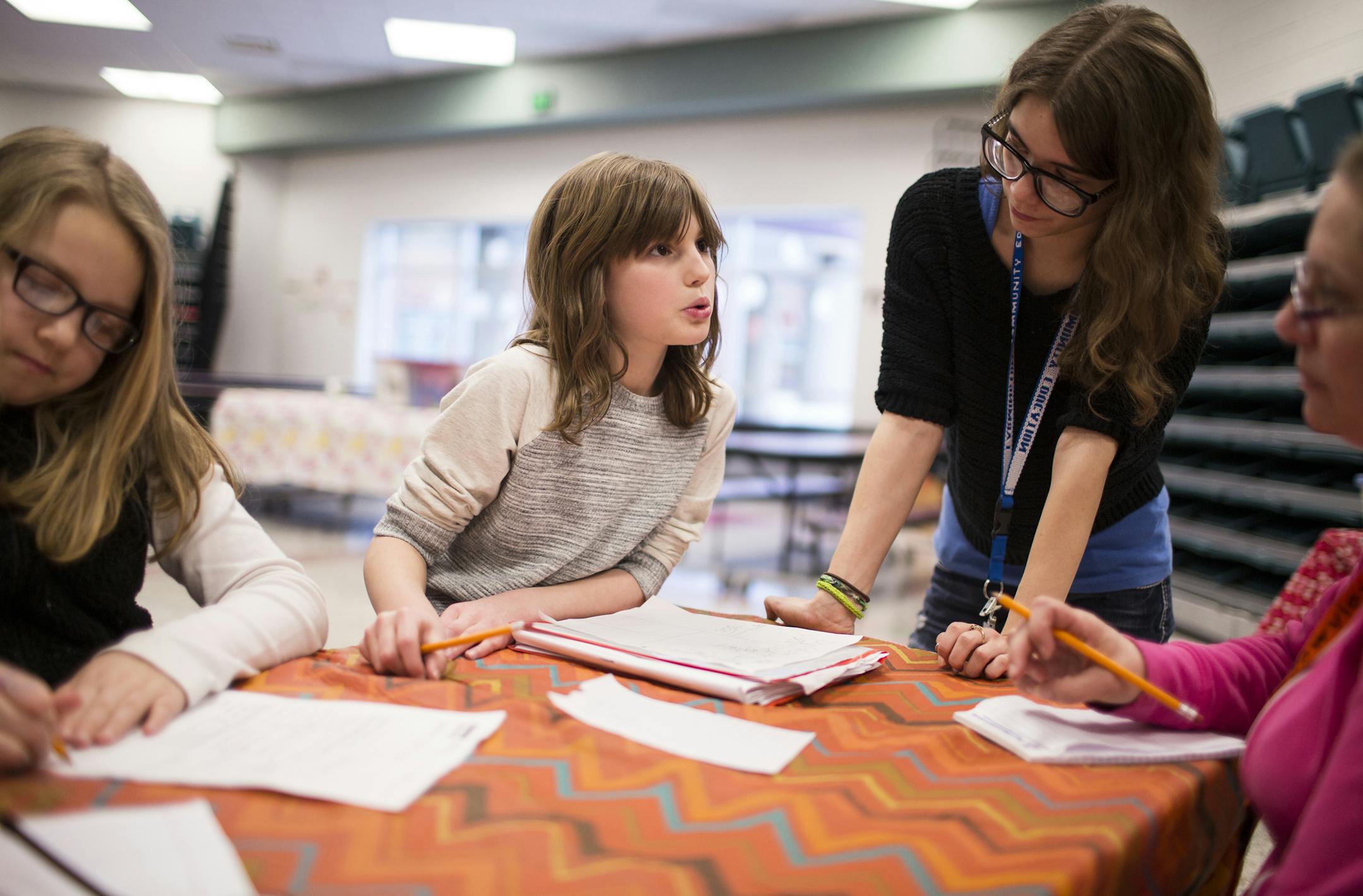 Fourth grader Danica Olson, left, gets help with her homework from Jaclyn Tano, right, an assistant with Kids Connection during the afterschool program at Meadowview Elementary School in Farmington on Tuesday, February 23, 2016. ] (Leila Navidi/Star Tribune) leila.navidi@startribune.com BACKGROUND INFORMATION: he Farmington district's flex days -- planned days when students work from home on district-provided iPads instead of coming into school -- have drawn national attention for their innovati