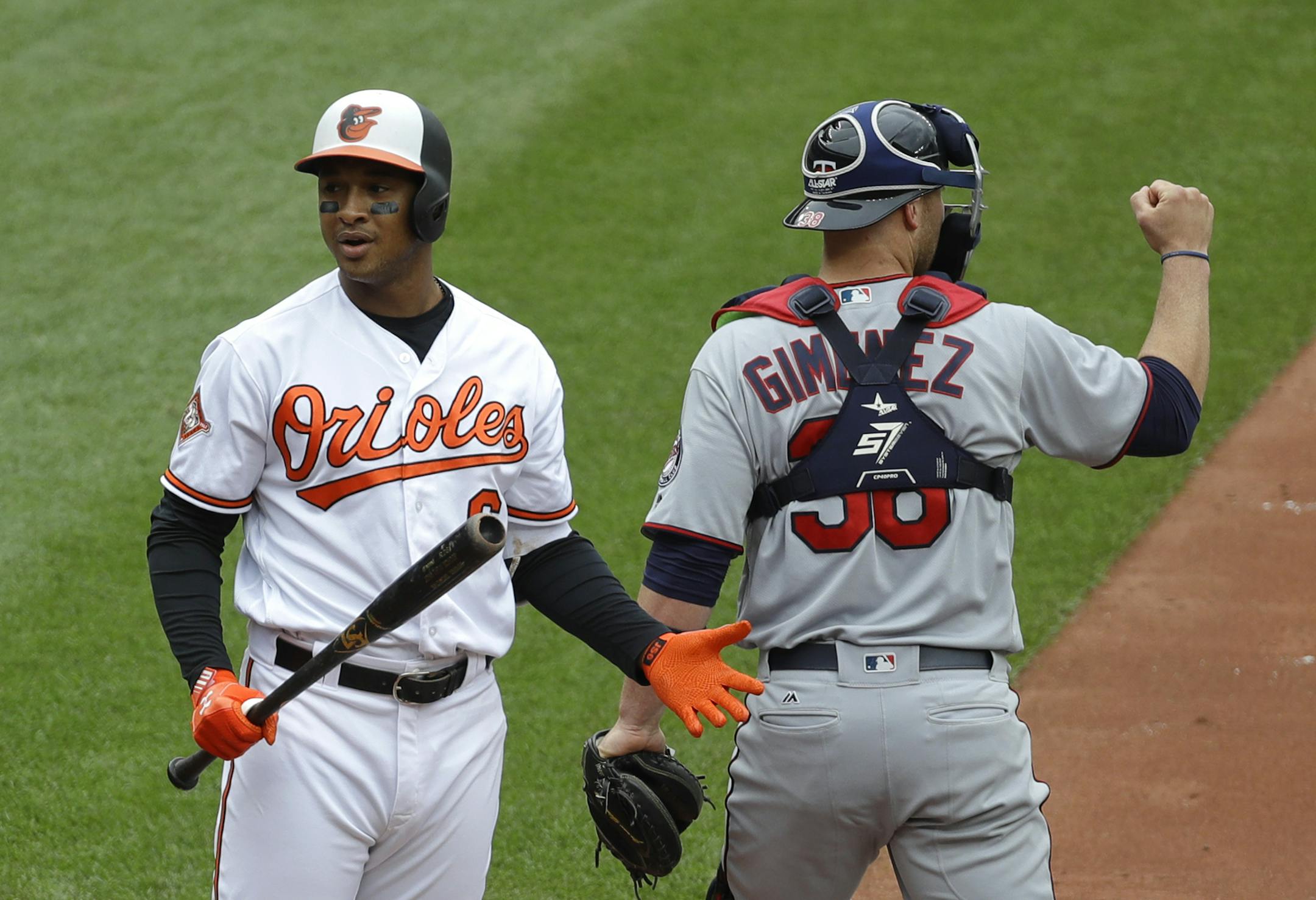 Baltimore Orioles' Jonathan Schoop, left, reacts in front of Minnesota Twins catcher Chris Gimenez after striking out swinging with the bases loaded to end the fourth inning of a baseball game in Baltimore, Wednesday, May 24, 2017. (AP Photo/Patrick Semansky)