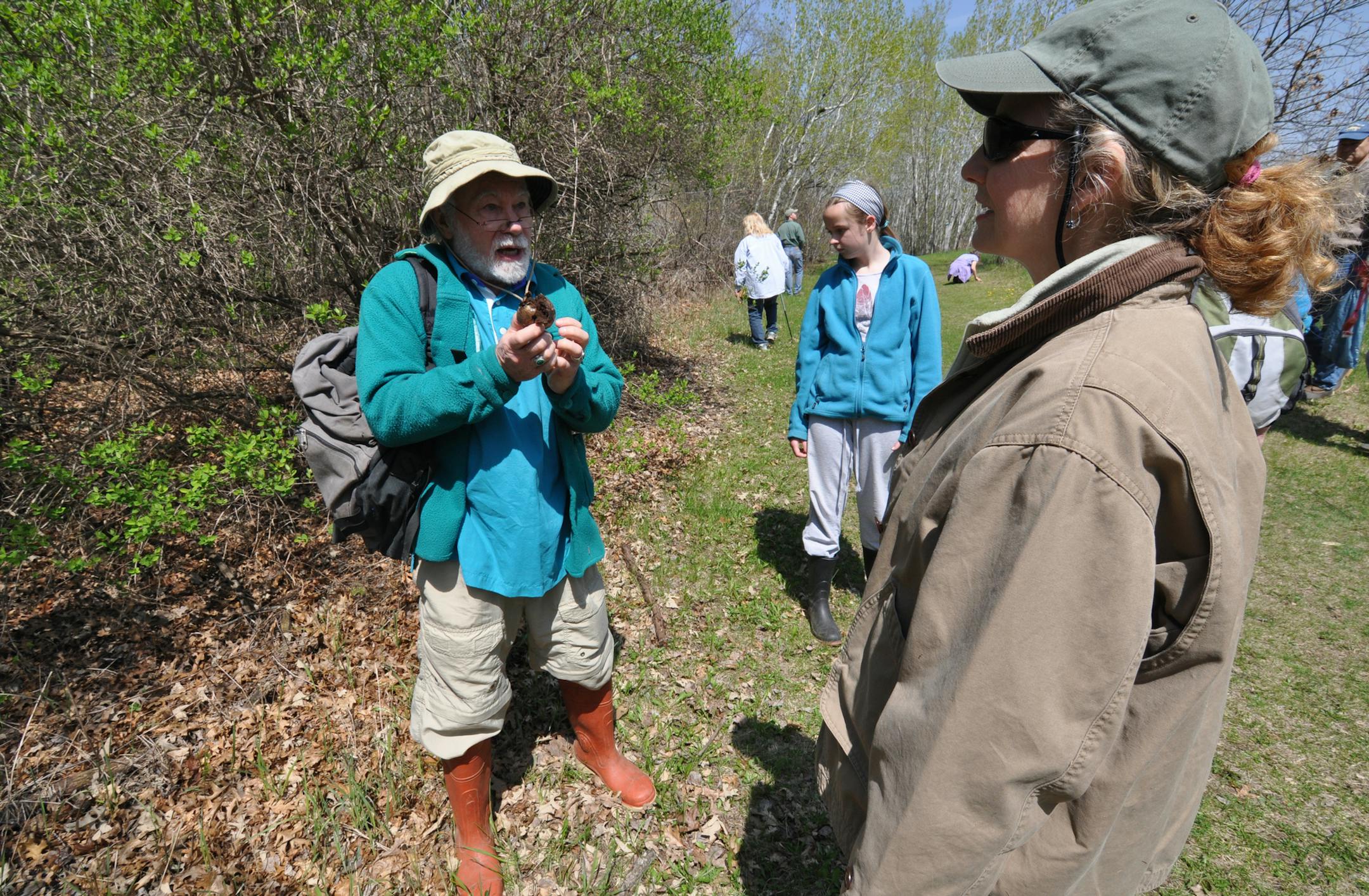 Photo by Liz Rolfsmeier Photo 3: Naturalist Dan Neubauer (left) talked to Pam Petty, of Lakeville, (right) about an edible mushroom, while Shannon Gallagher, 13, of Lakeville, (middle) looked for morels at Ritter Farm Park.