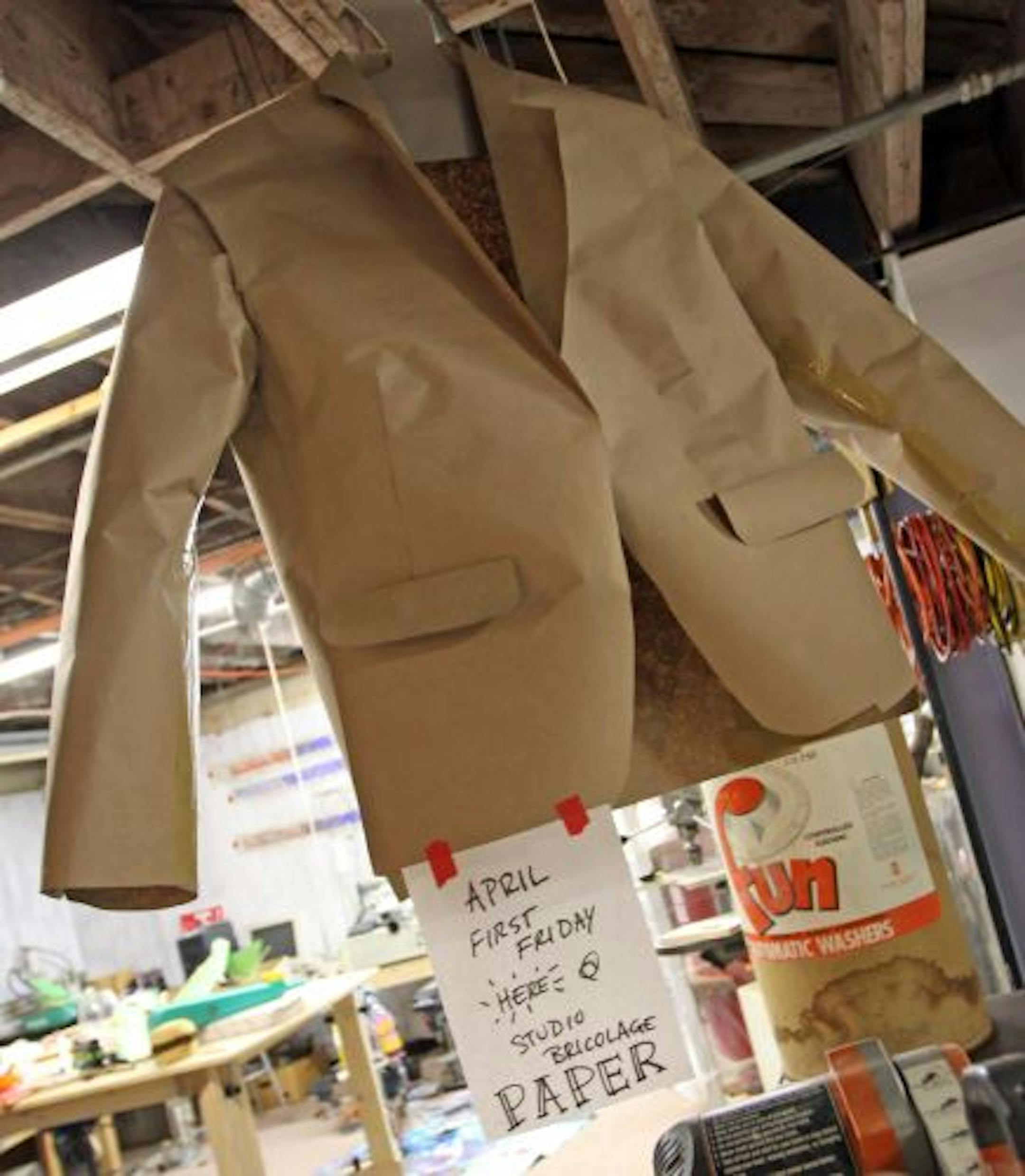 A paper suit let Studio Bricolage attendees know about next months class, as they assembled sections of a 150-foot causation machine on the floor of Leonardo's Basement.