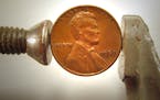 An American penny in a C-clamp.Check out