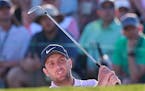 Francesco Molinari hits a bunker shot to the 18th green during the third round of the Masters at Augusta National Golf Club in Augusta, Ga., on Saturd