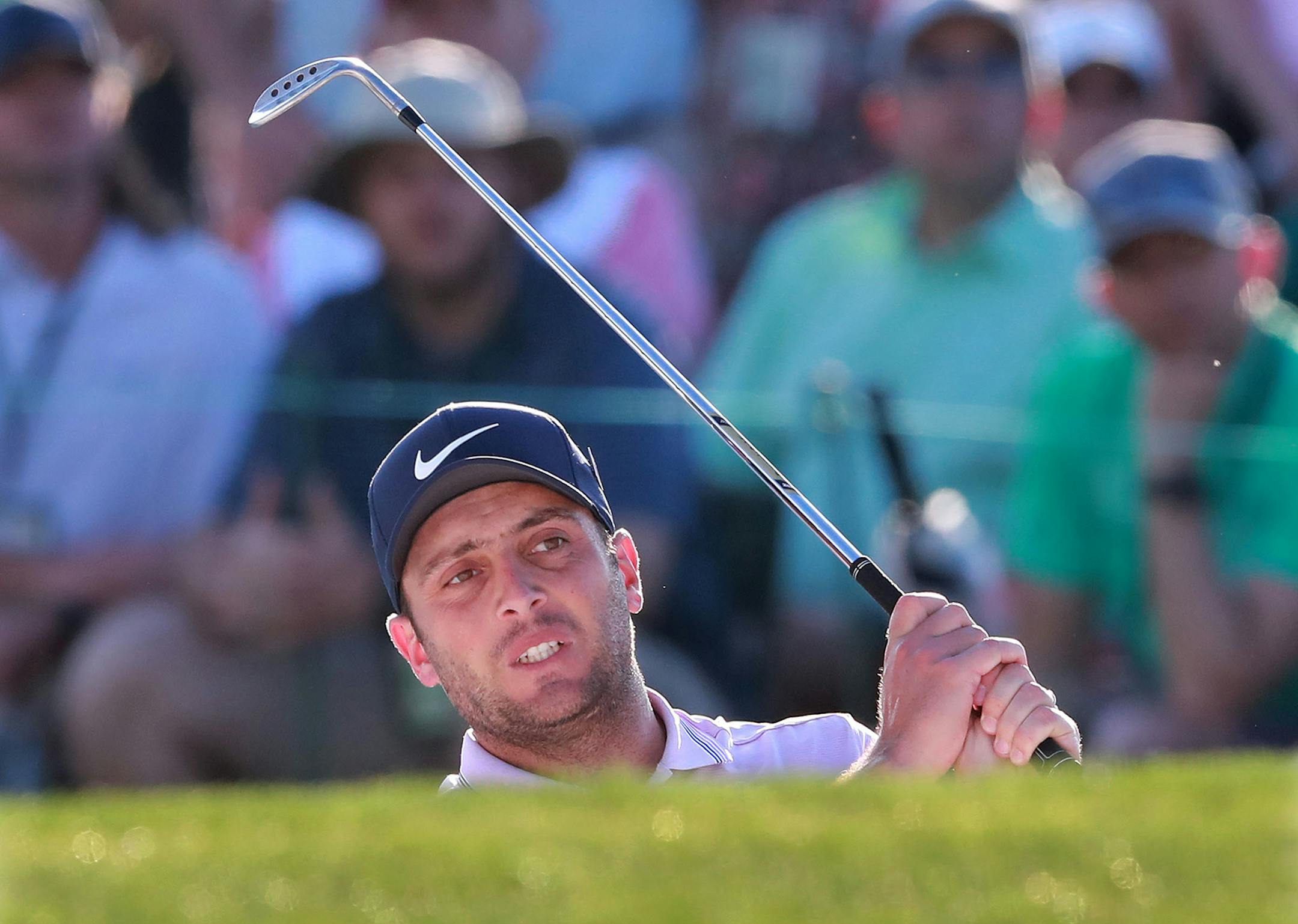 Francesco Molinari hits a bunker shot to the 18th green during the third round of the Masters at Augusta National Golf Club in Augusta, Ga., on Saturday, April 13, 2019. (Curtis Compton/Atlanta Journal-Constitution/TNS)