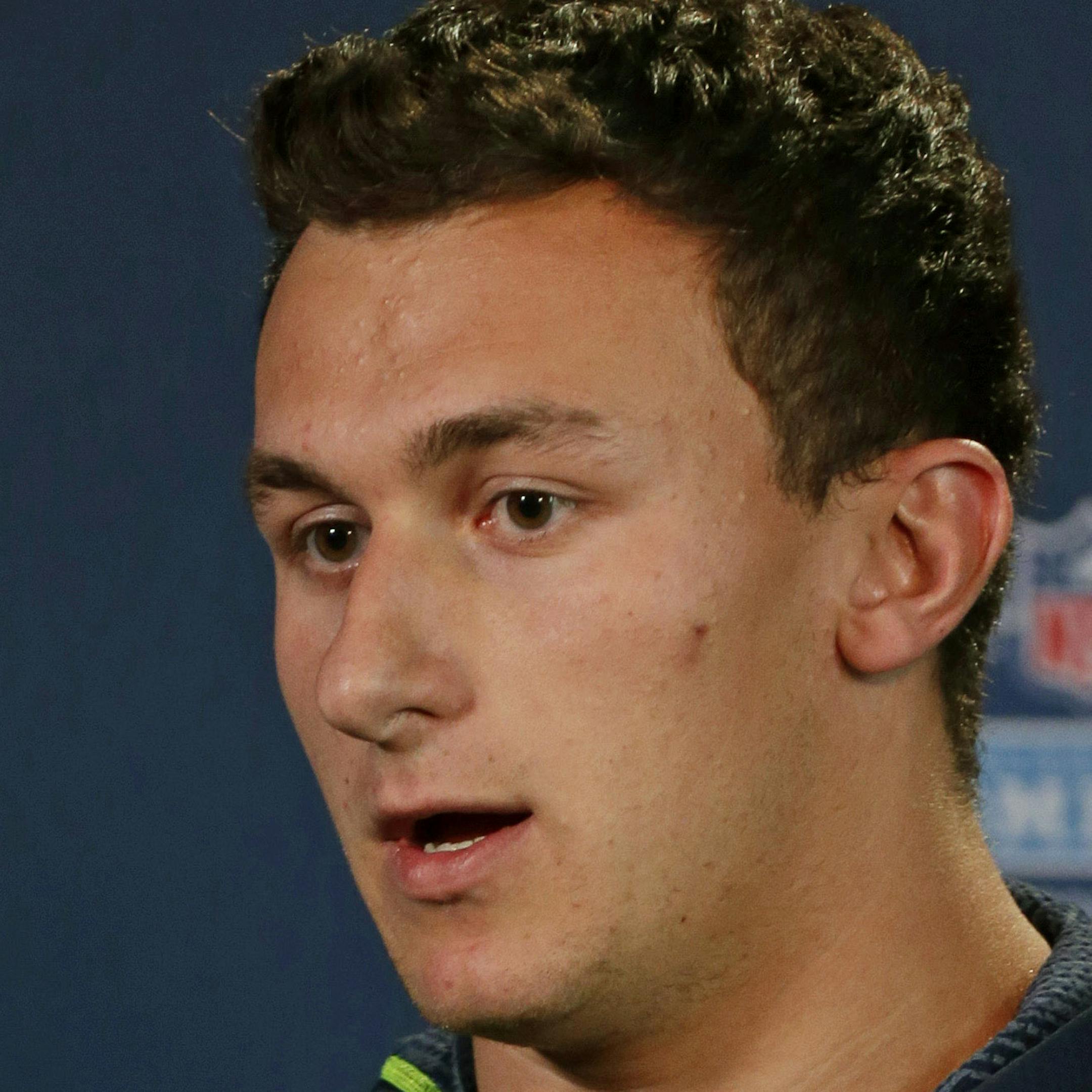 Texas A&M quarterback Johnny Manziel answers a question during a news conference at the NFL football scouting combine in Indianapolis, Friday, Feb. 21, 2014. (AP Photo/Michael Conroy)