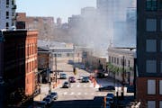 Smoke from the building fire on East Hennepin Ave. emerges on Sunday in Minneapolis.