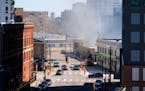 Smoke from the building fire on East Hennepin Ave. emerges on Sunday in Minneapolis.