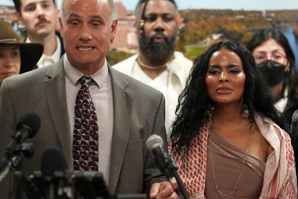 Mashal Sherzad, right, and her attorney, Jordan Kushner, left, appear at a Friday news conference announcing she’s filed a lawsuit against the Unive