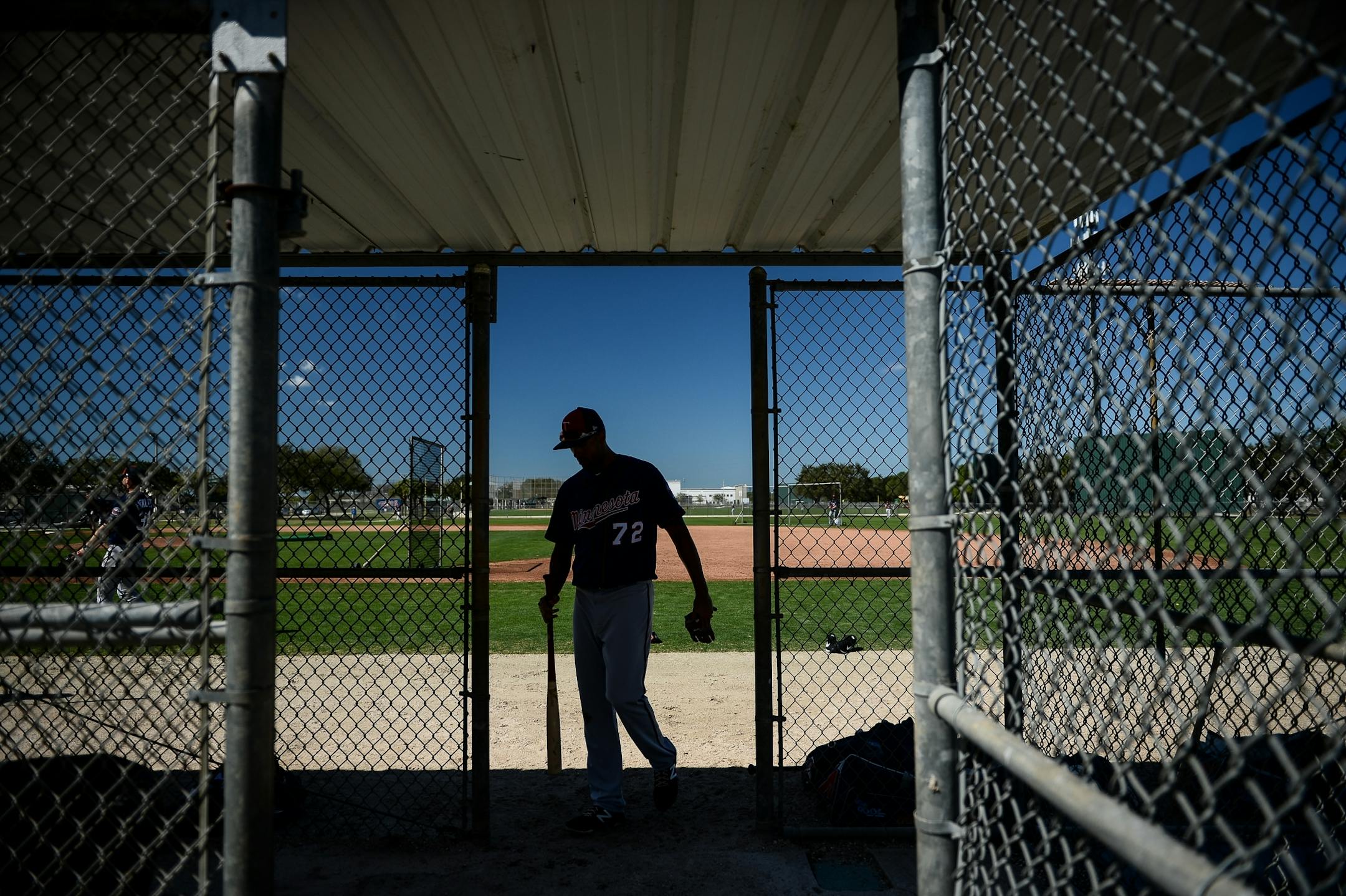 Minnesota Twins shortstop Leonardo Reginatto (72) walkd into a backfield dugout for a drink of water during live batting practice Monday.