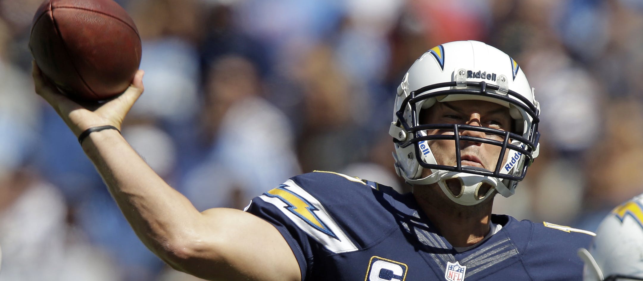 San Diego Chargers quarterback Philip Rivers (17) passes as Tennessee Titans defensive end Derrick Morgan (91) rushes in the first quarter of an NFL football game on Sunday, Sept. 22, 2013, in Nashville, Tenn. (AP Photo/Wade Payne)