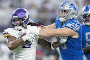 Vikings running back Alexander Mattison (2) is stopped by Lions defensive end John Cominsky (79) in the fourth quarter at U.S. Bank Stadium, in Minnea