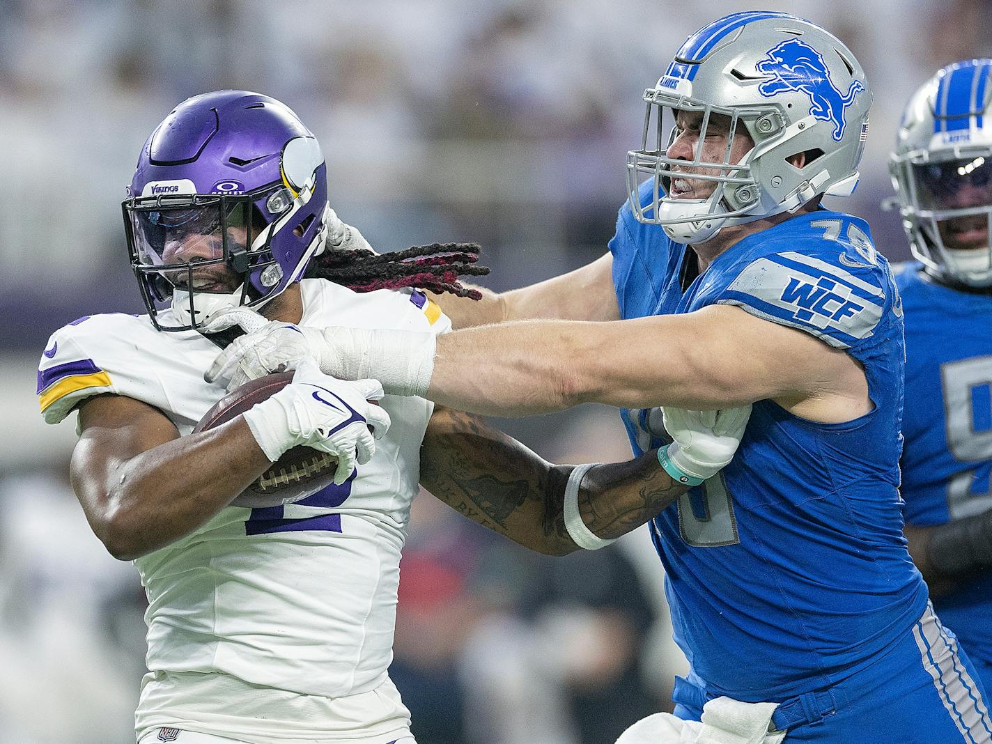 Vikings running back Alexander Mattison (2) is stopped by Lions defensive end John Cominsky (79) in the fourth quarter at U.S. Bank Stadium, in Minneapolis, Minn., on Sunday, Dec. 24, 2023.   ] Elizabeth Flores • liz.flores@startribune.com