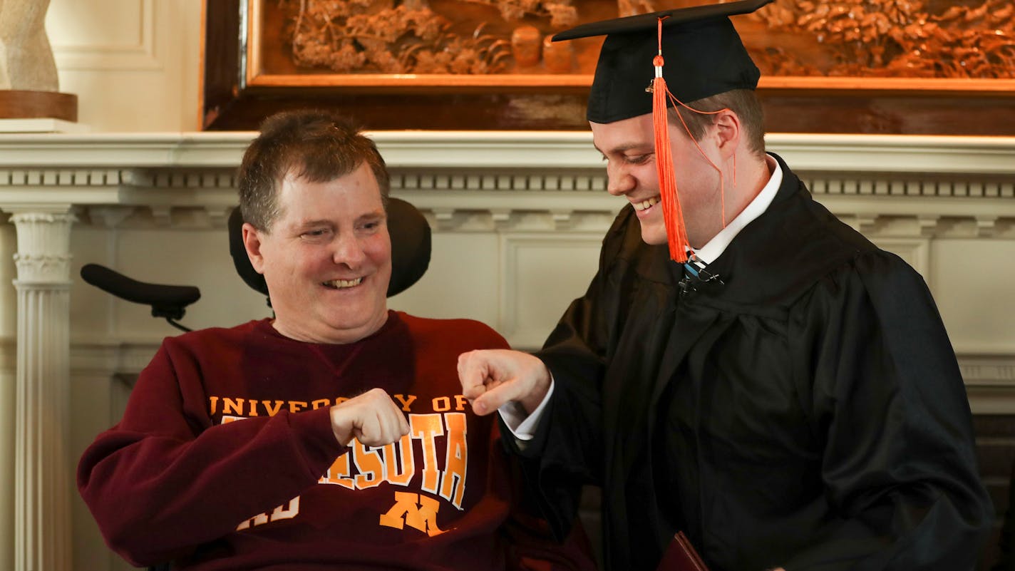 Ken Brown and his on, Collin, laughed they fist bumped to celebrate Collin's graduation from the University of Minnesota Monday afternoon. ] JEFF WHEELER • jeff.wheeler@startribune.com With his father, Ken, and family in attendance, Collin Brown graduated in what is believed to be the first one-person commencement ceremony of the University of Minnesota Monday afternoon, March 20, 2107 at Eastcliff, the official residence of the president of the U of M in St. Paul.