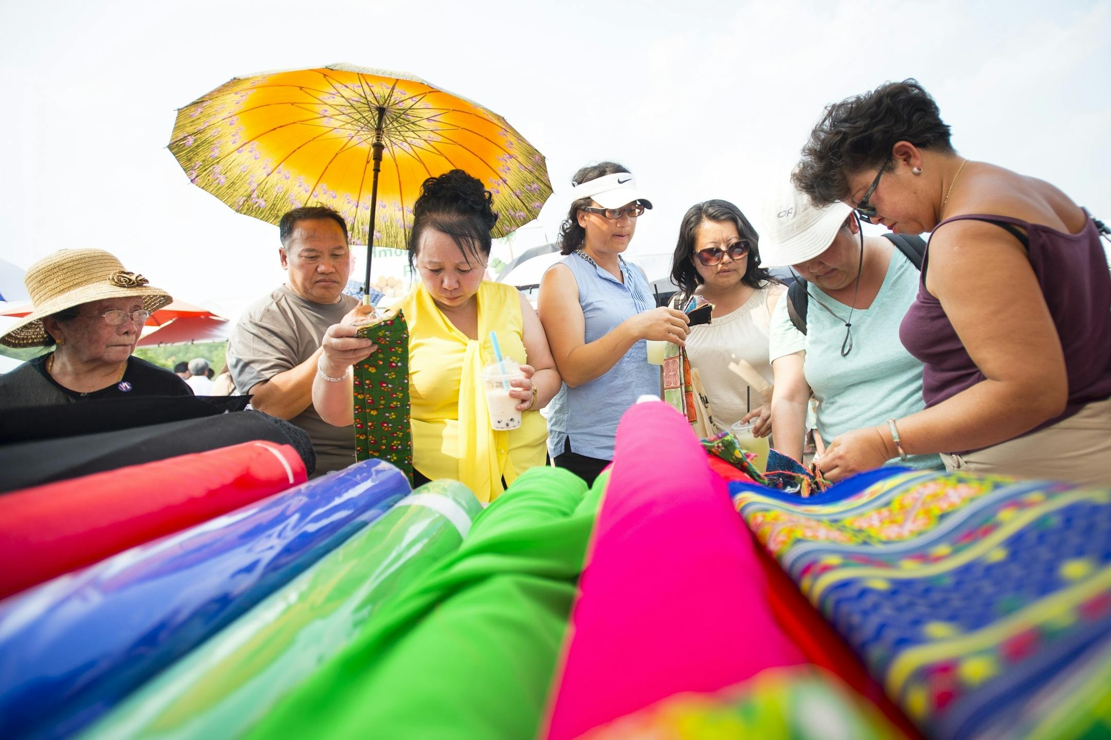 Members of the Hmong community shopped for fabrics used for traditional dresses worn by women during the Hmong New Years and weddings.