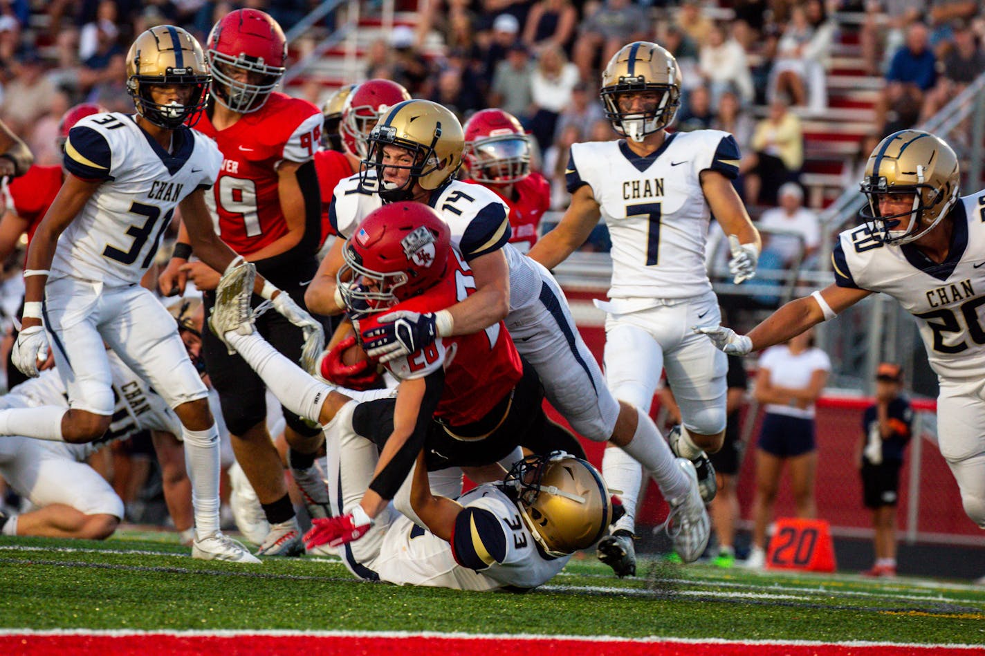 Elk River running back Gavin Schmidt (28) is tackled just shy of the end zone by Chanhassen linebacker Carter Carstens (14) in the first half of the opening night game between Elk River High School and Chanhassen High School Thursday, Aug. 31, 2023 at Elk River High School.