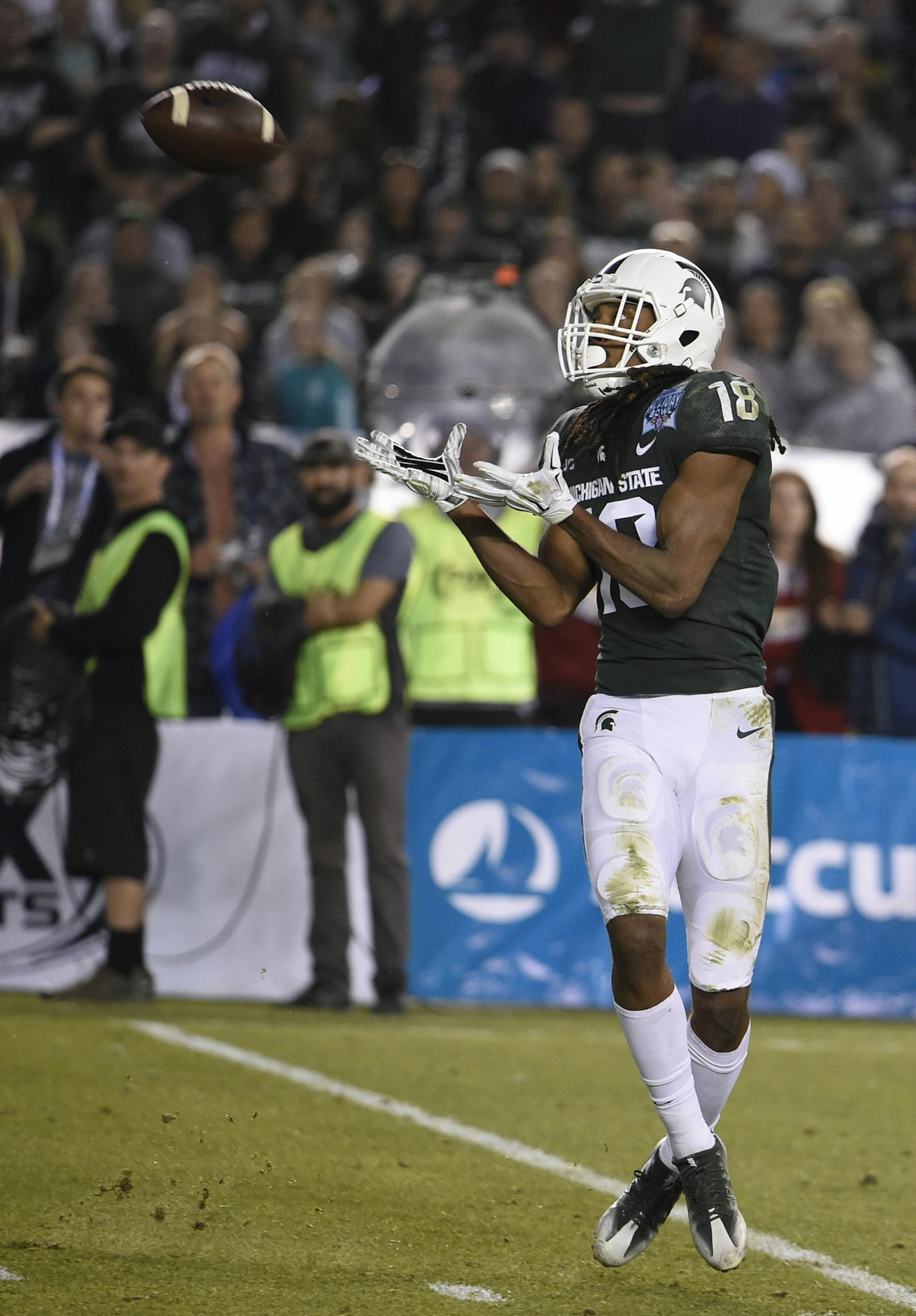 Michigan State wide receiver Felton Davis III (18) makes a touchdown catch during the first half of the Holiday Bowl NCAA college football game against Washington State on Thursday, Dec. 28, 2017, in San Diego. (AP Photo/Denis Poroy)