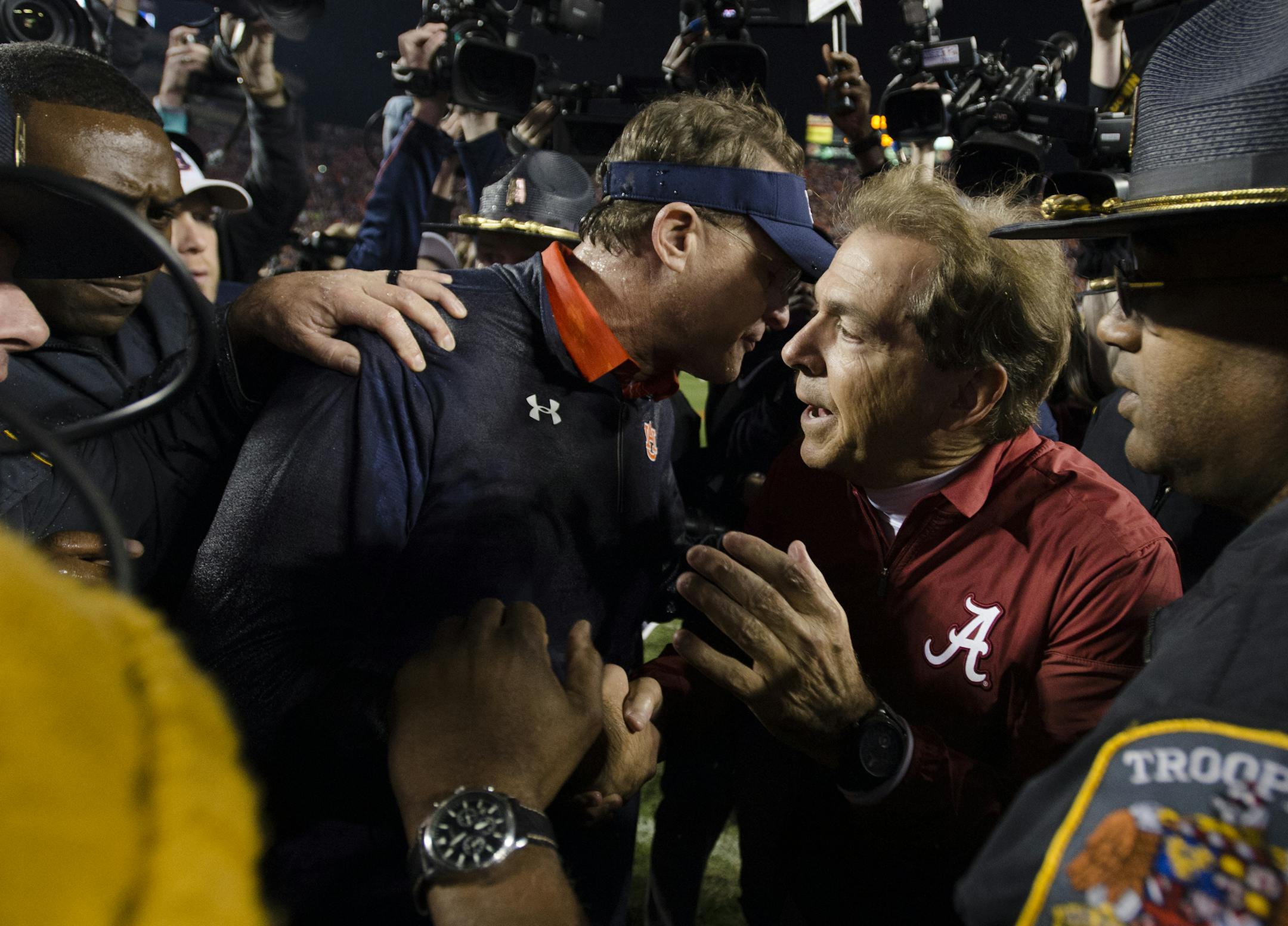 Auburn coach Gus Malzahn greets Alabama coach Nick Saban after the Iron Bowl NCAA football game Saturday, Nov. 25, 2017, in Auburn, Ala. (Albert Cesare/The Montgomery Advertiser via AP)
