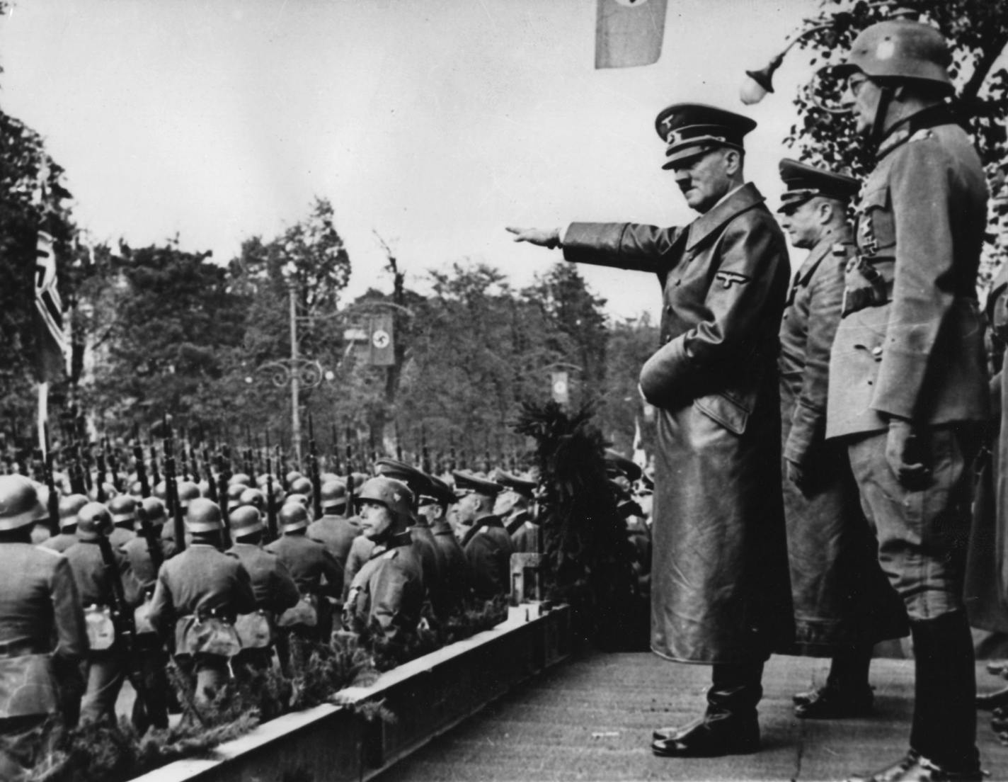 ** FILE ** In this March 1938 file photo, Adolf Hitler, salutes German troops parading in Vienna, Austria. March 12, 2008 is the 70th anniversary of Nazi Germany's annexation of Austria. On the same Vienna square where thousands gave Hitler an adoring welcome in 1938, Austria marked the occasion by lighting 80,000 candles _ one for each Jew and Austrian "undesirable" who perished. (AP Photo)