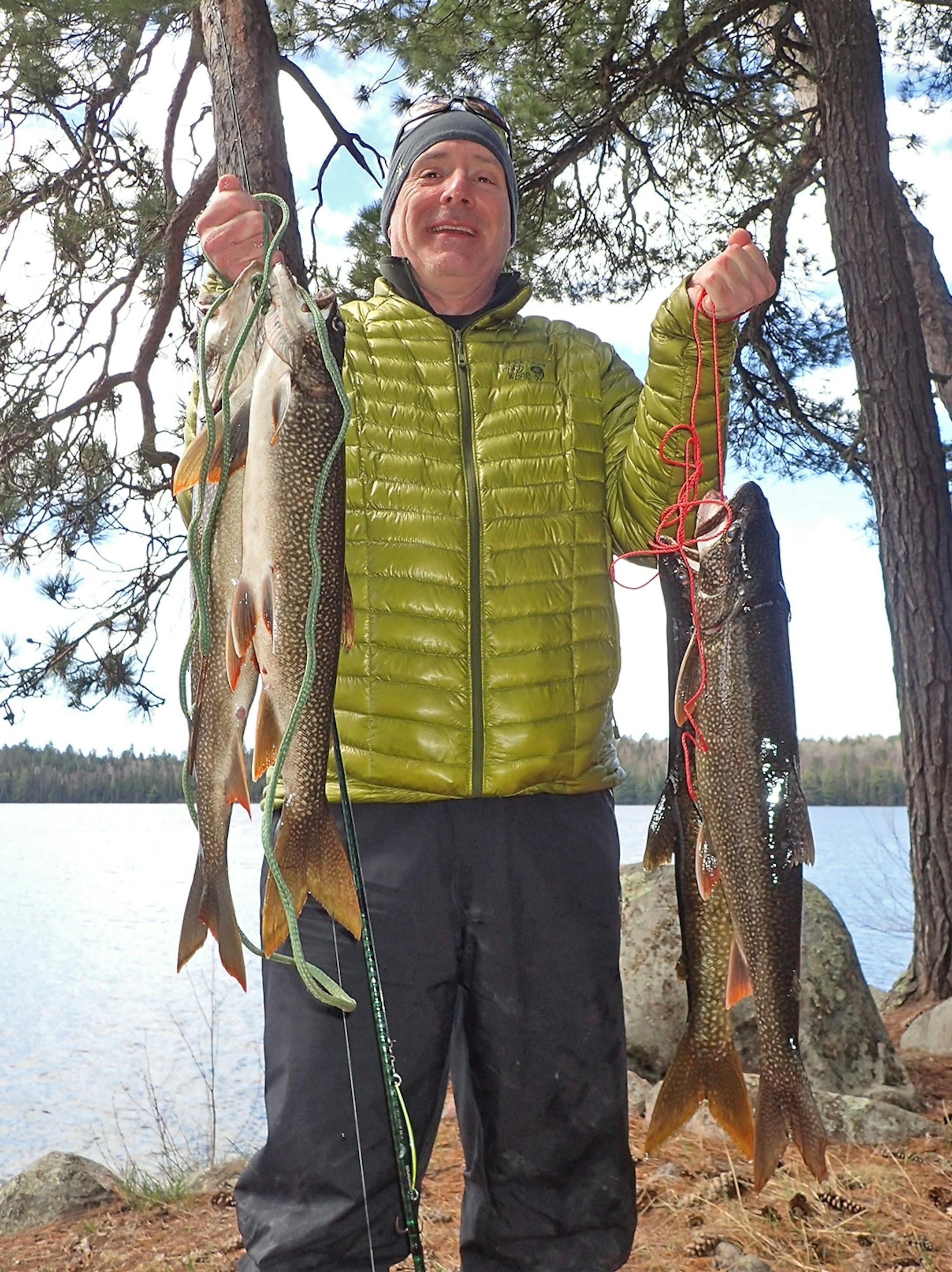 Bill Spohn of Duluth with four lake trout � one apiece caught by Spohn, his son, Carson, Aaron Youngblom and Star Tribune outdoors writer Tony Kennedy. The Spohns and Youngblom are from Duluth, Kennedy from the Twin Cities.