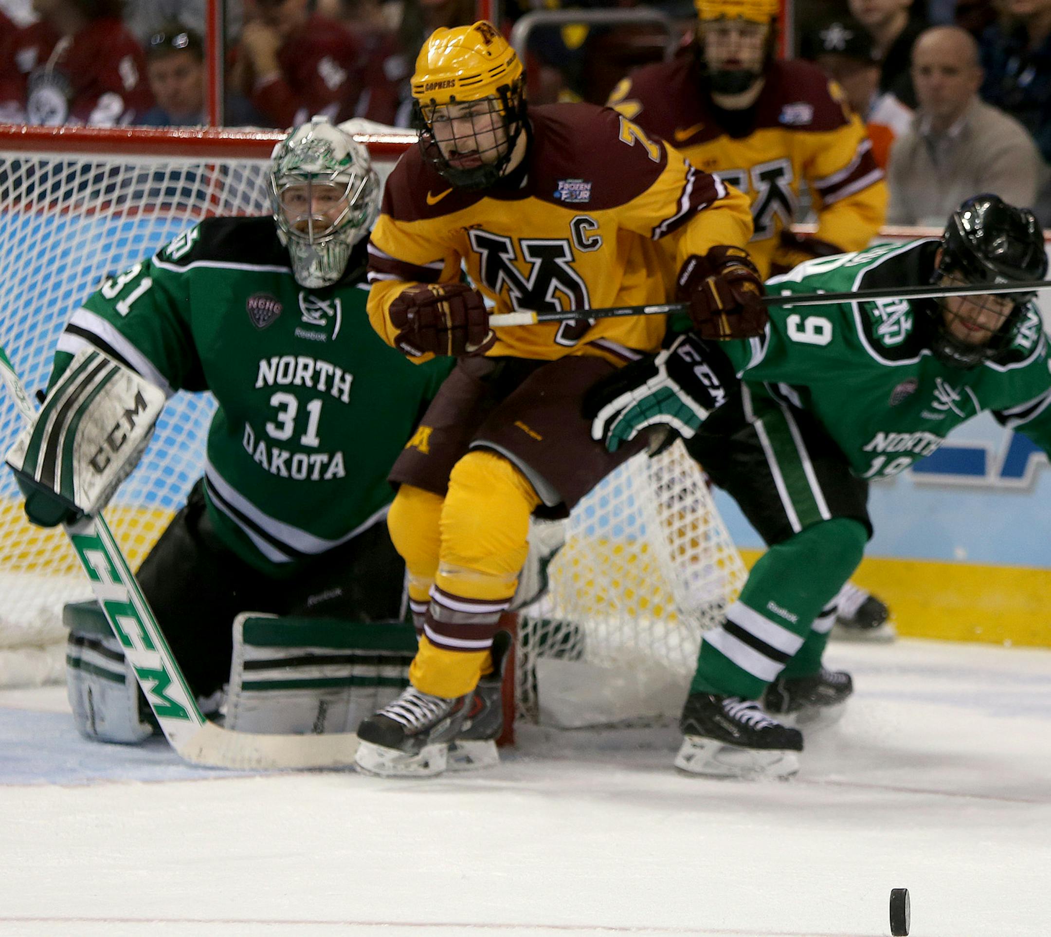 Minnesota Gophers Kyle Rau and North Dakota'sRocco Grimaldi battled for the puck at the net during the second period during the Frozen Four at the Wells Fargo Center in Philadelphia, PA, Thursday, April 10, 2014. ] (ELIZABETH FLORES/STAR TRIBUNE) ELIZABETH FLORES • eflores@startribune.com