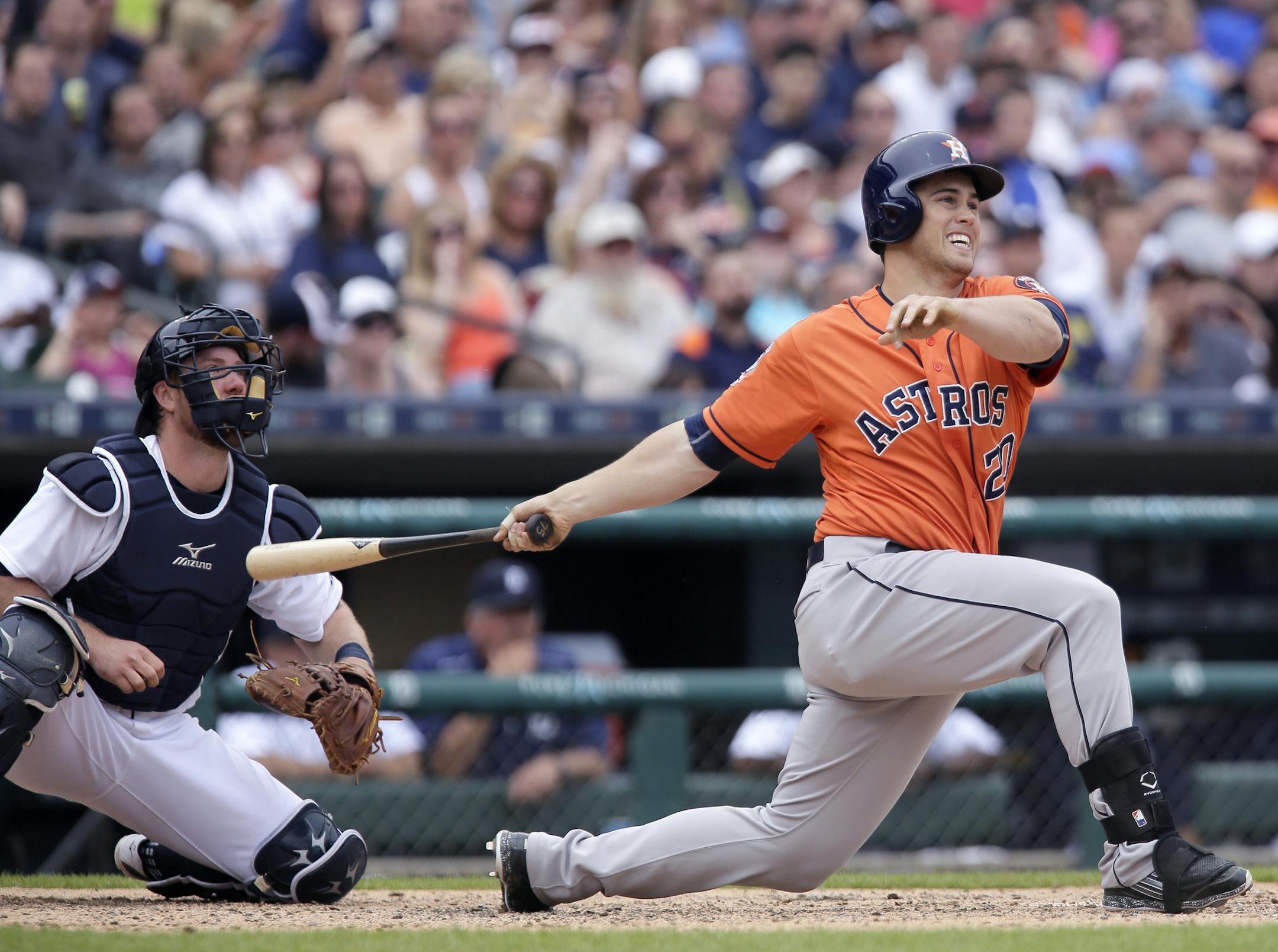 Houston Astros' Preston Tucker (20) watches his three-run home run with Detroit Tigers catcher Bryan Holaday, tying the game at 7-7, during the sixth inning of a baseball game Sunday, May 24, 2015, in Detroit. (AP Photo/Duane Burleson)