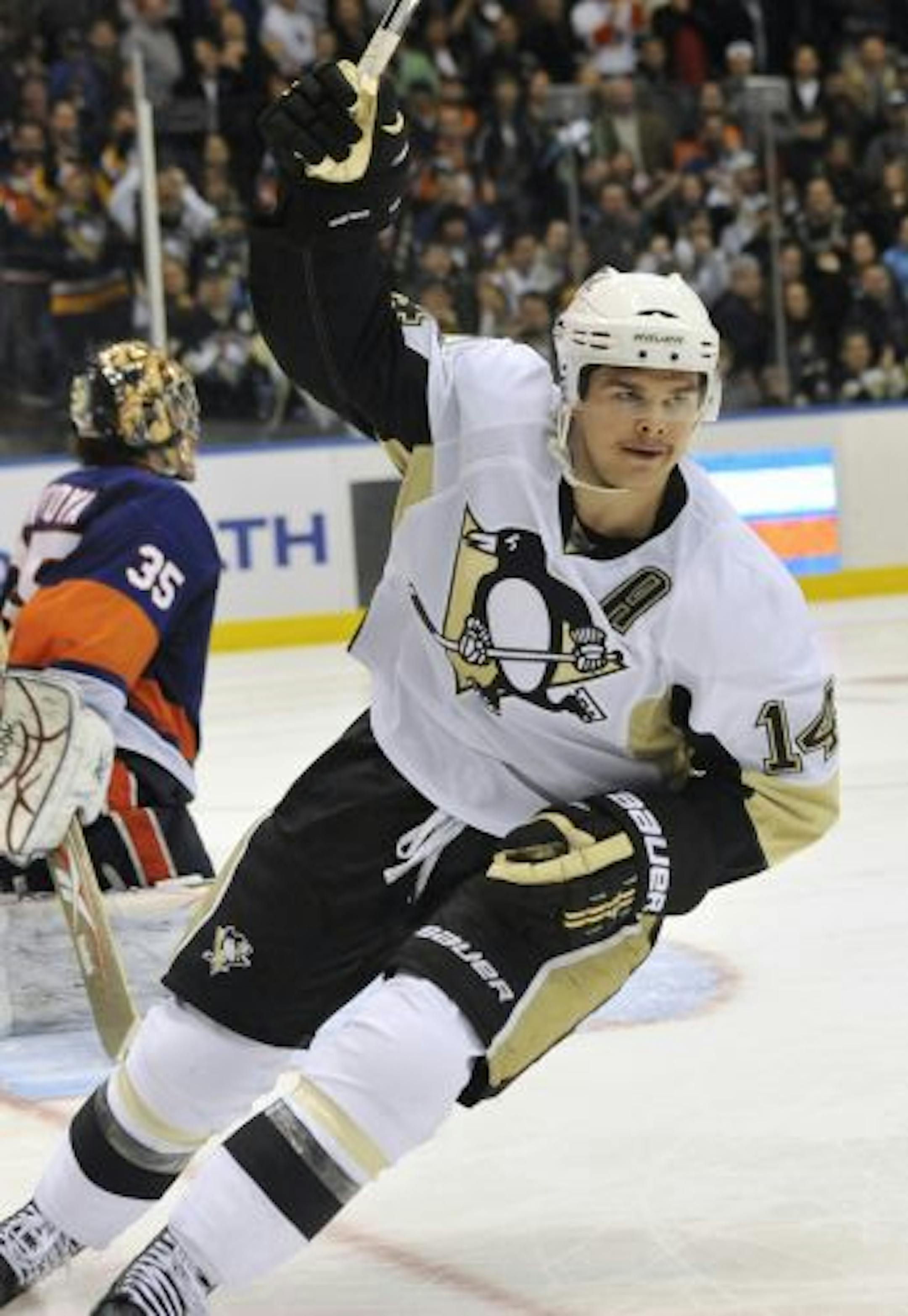 Pittsburgh Penguins' Chris Kunitz (14) celebrates his shootout goal against New York Islanders goalie Al Montoya (35) during an NHL hockey game Friday, April 8, 2011, in Uniondale, N.Y. The Penguins won 4-3 in a shootout.