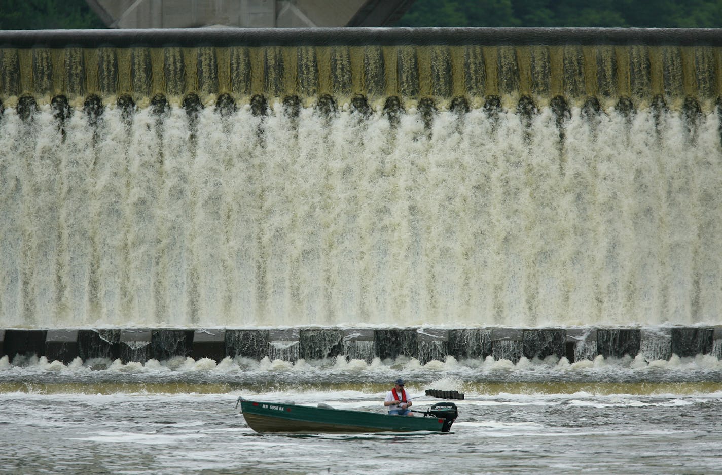 JEFF WHEELER &#x2022; jwheeler@startribune.com ST. PAUL - 5/14/07 - Fish are drawn to the turbulent waters beneath dams along the Mississippi River, as well as the anglers who pursue them, even following the boating mishap that resulted in four deaths below a dam in southern Minnesota over the weekend. IN THIS PHOTO: Woody Jaspersen fished below the Ford Dam on the Mississippi River Monday afternoon after work. He said that now that the water has settled down, he'll be fishing downstream from th