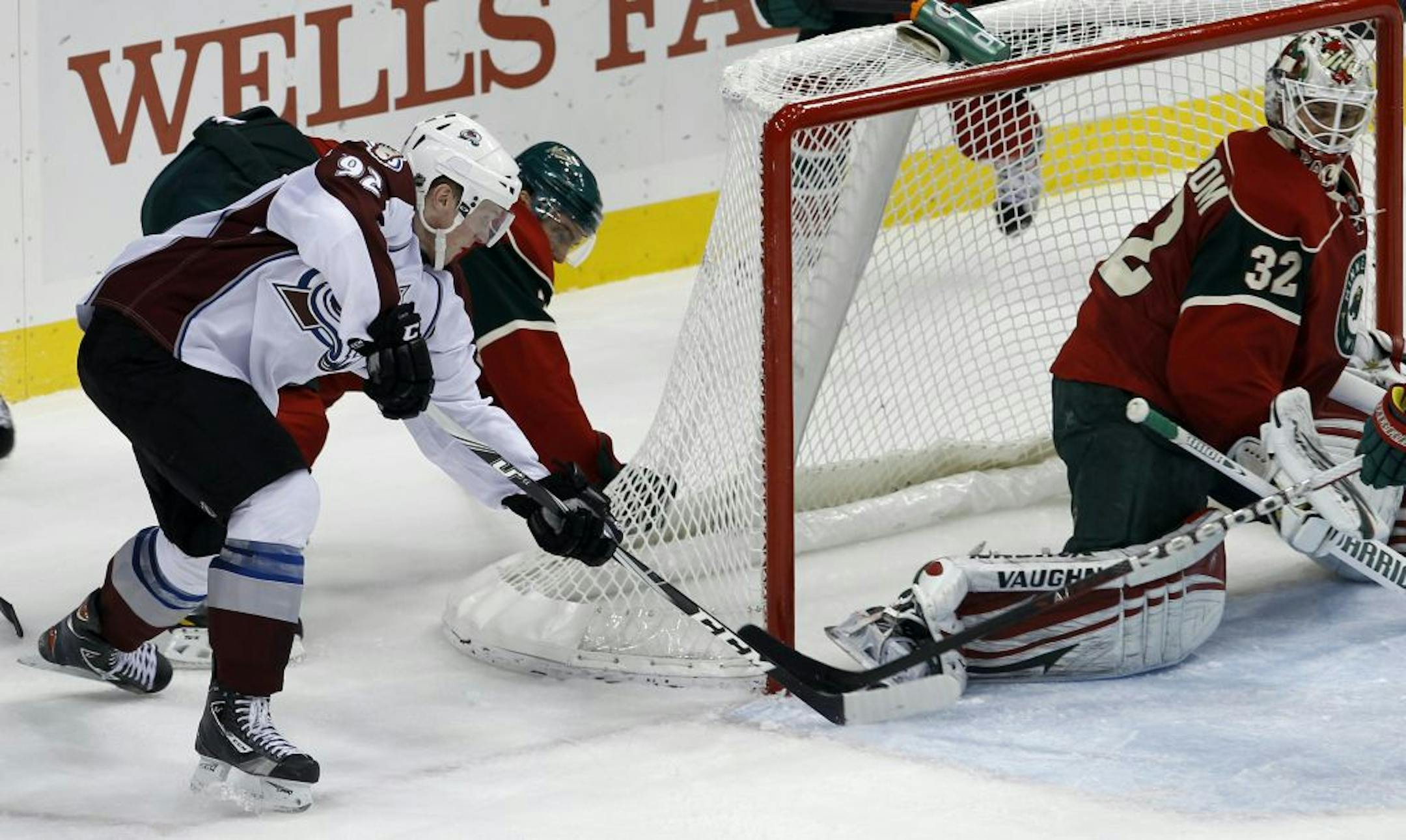 Colorado Avalanche left wing Gabriel Landeskog (92) of Sweden shoots the puck between the post and the skate of Minnesota Wild goalie Niklas Backstrom (32) of Finland to score as Wild defenseman Mike Lundin tries to defend during the second period of an NHL hockey game in St. Paul, Minn., Monday, Dec. 26, 2011.