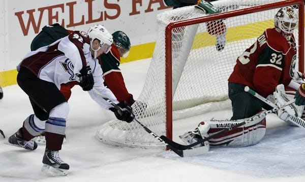 Colorado Avalanche left wing Gabriel Landeskog (92) of Sweden shoots the puck between the post and the skate of Minnesota Wild goalie Niklas Backstrom