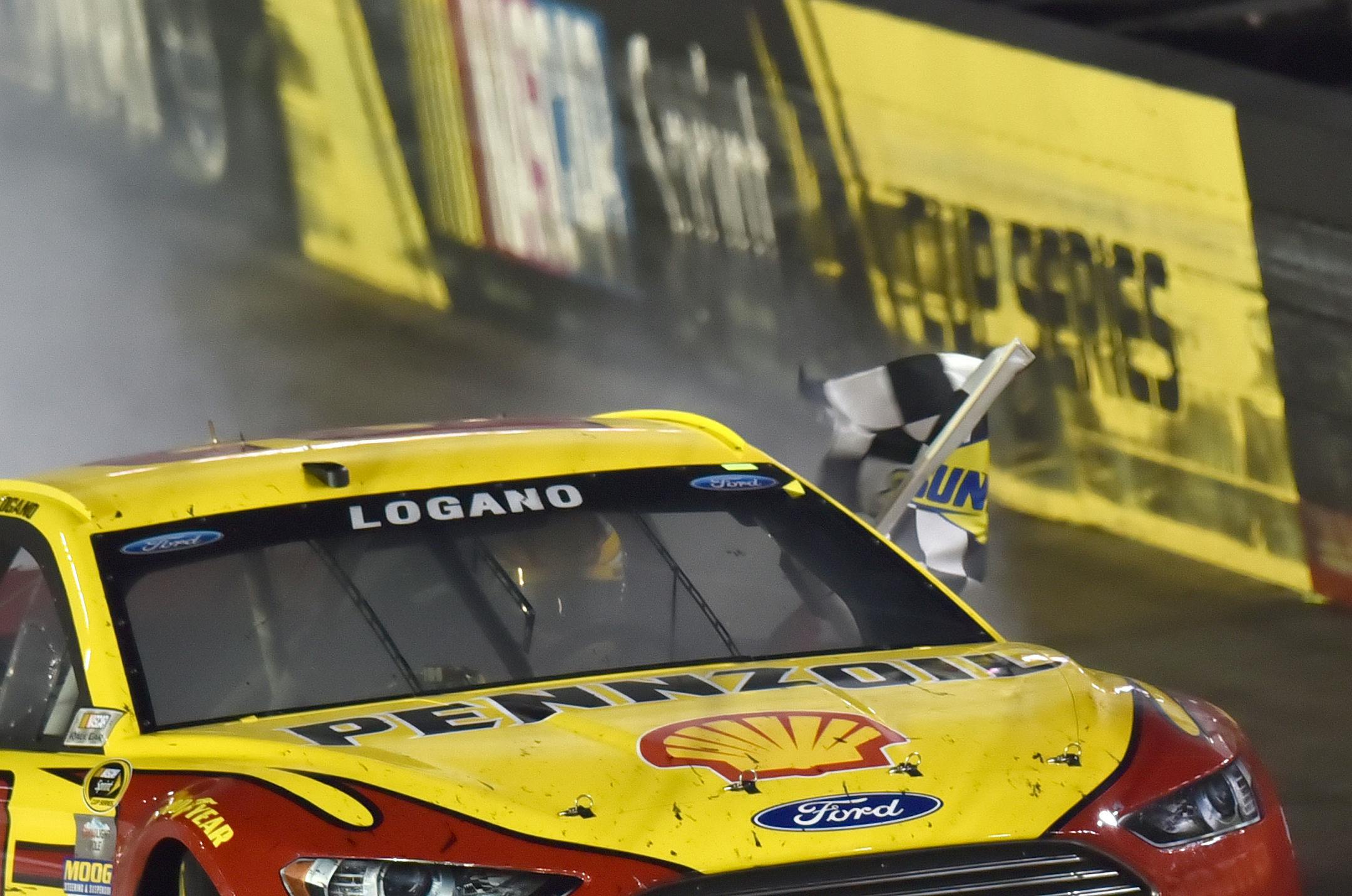 Joey Logano celebrates his victory in the NASCAR Sprint Cup series auto race Saturday night, Aug. 22, 2015, at Bristol Motor Speedway in Bristol, Tenn. (Andre Teague/Bristol Herald Courier via AP)