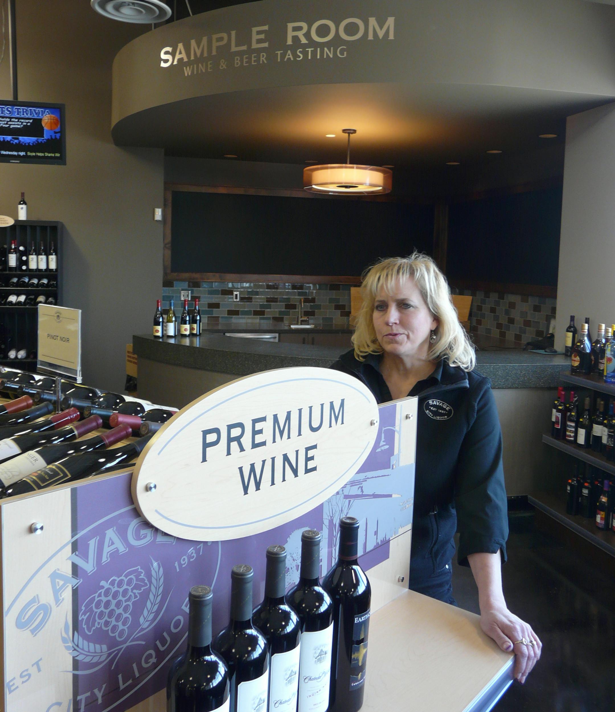 Photo by David Peterson Savageís director of liquor operations, Stacy Schmidt, in a store bursting with imagery drawn from the city as it repositions itself as a benefit to the city coffers rather than just a store like any other.