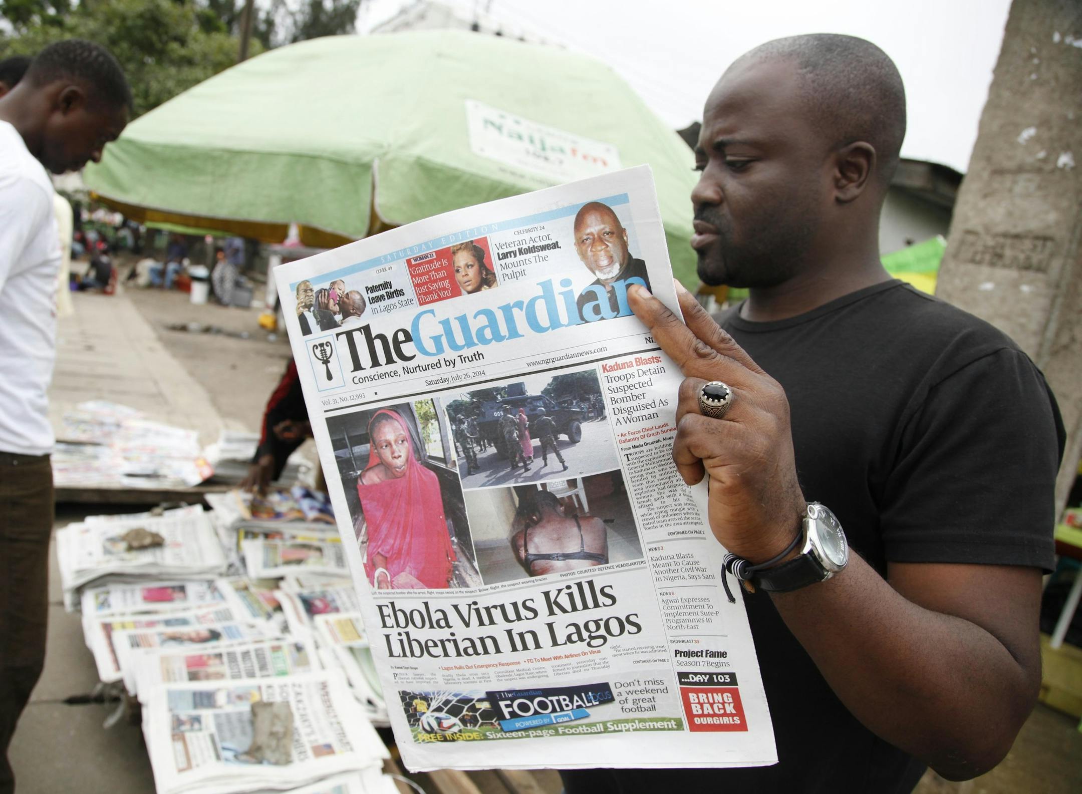 A man reads a local newspaperson a street with the headline Ebola Virus kills Liberian in Lagos, in Lagos Nigeria, Saturday, July 26, 2014. An Ebola outbreak that has left more than 600 people dead across West Africa has spread to the continent's most populous nation after a Liberian man with a high fever vomited aboard an airplane to Nigeria and then died there, officials said Friday. (AP Photo/Sunday Alamba) The 40-year-old man had recently lost his sister to Ebola in Liberia, health officials
