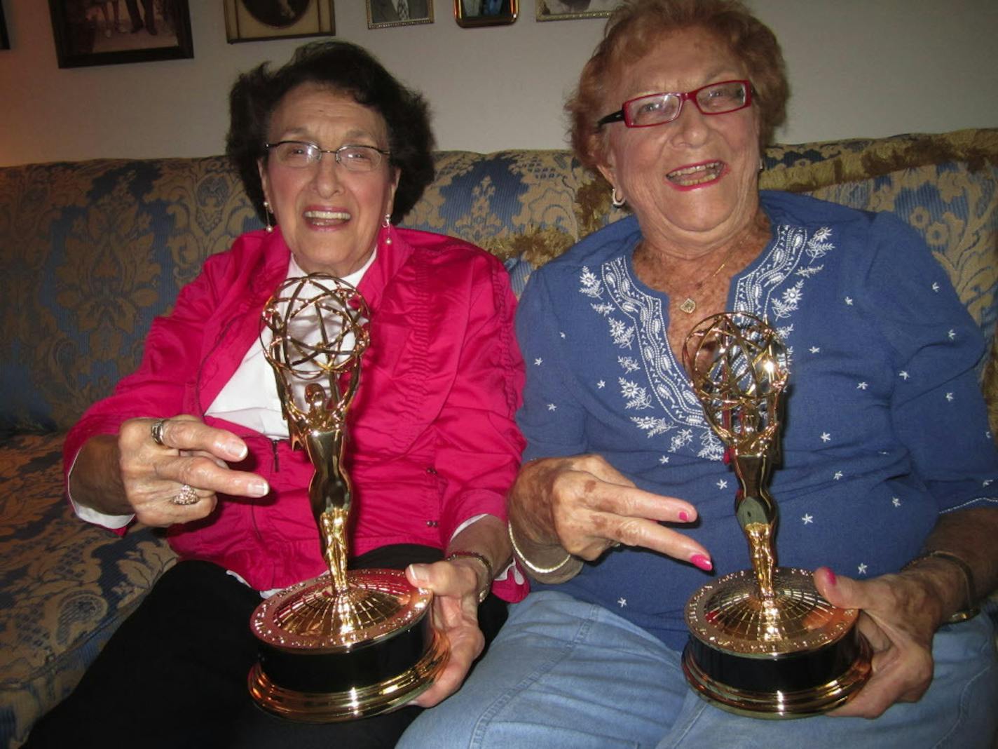 Rosalie Vascellaro, mother of WCCO-TV anchor Frank Vascellaro, and Doris Rosen, mother of WCCO-TV sports anchor Mark Rosen, show off Emmys won for their 2011 "Grannies Take On the Grammys" segment on WCCO-TV. They are flashing the peace sign the way some Grammy winners do when picking up hardware at the awards celebration.